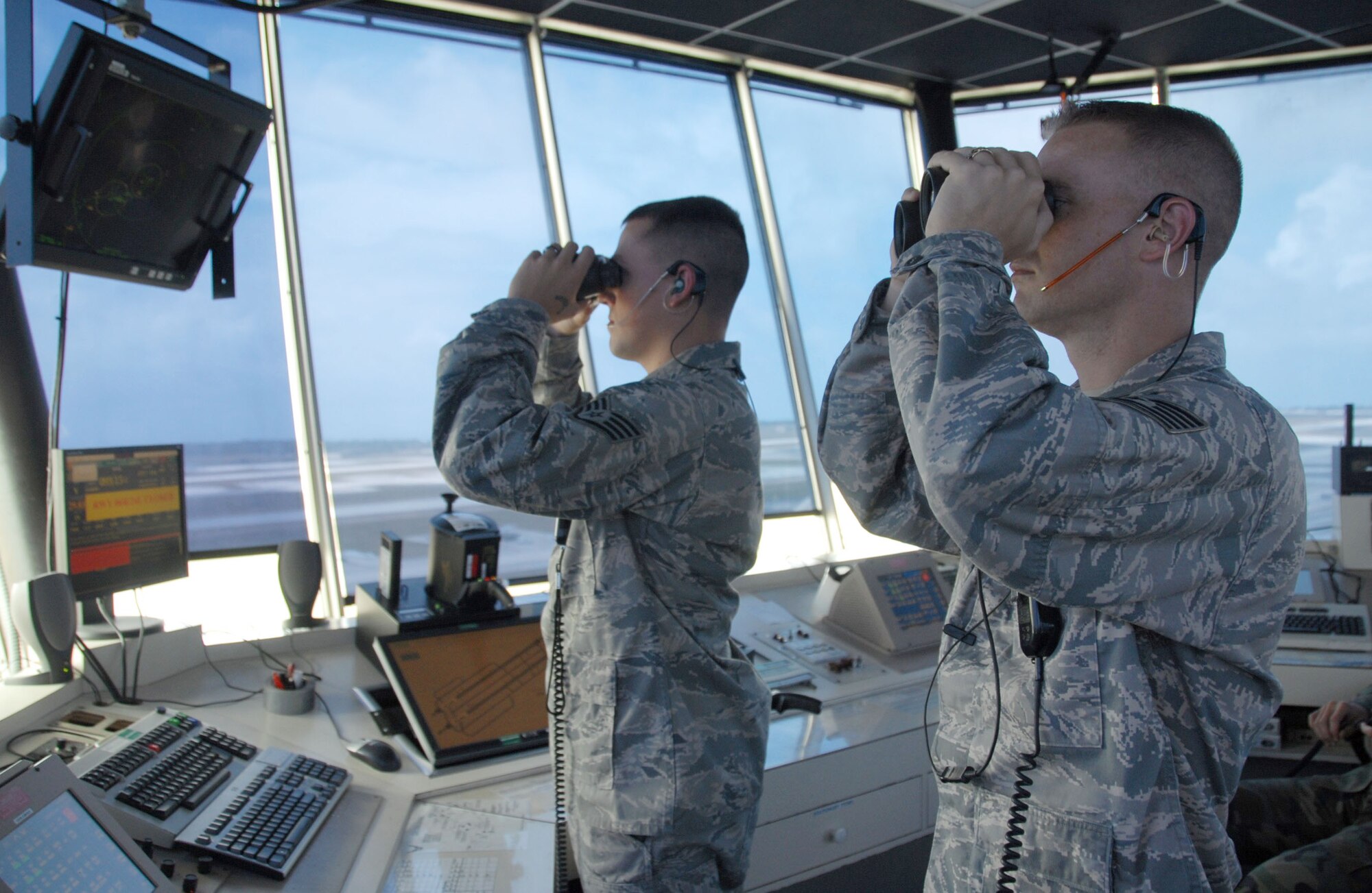 ANDERSEN AIR FORCE BASE, Guam – Staff Sgt. Samuel Parker, 36th Operations Support Squadron air traffic controller, and Tech. Sgt. Jason Trickey, 36th OSS NCO-in-charge of air traffic control training and standardization, demonstrate how air traffic controllers use binoculars to determine whether an aircraft’s landing gear is down or not here May 6. Air traffic controllers work closely with other 36th OSS flights to ensure pilots are permitted to take off and land aircraft safely. (U.S. Air Force photo by Senior Airman Shane Dunaway)

 
