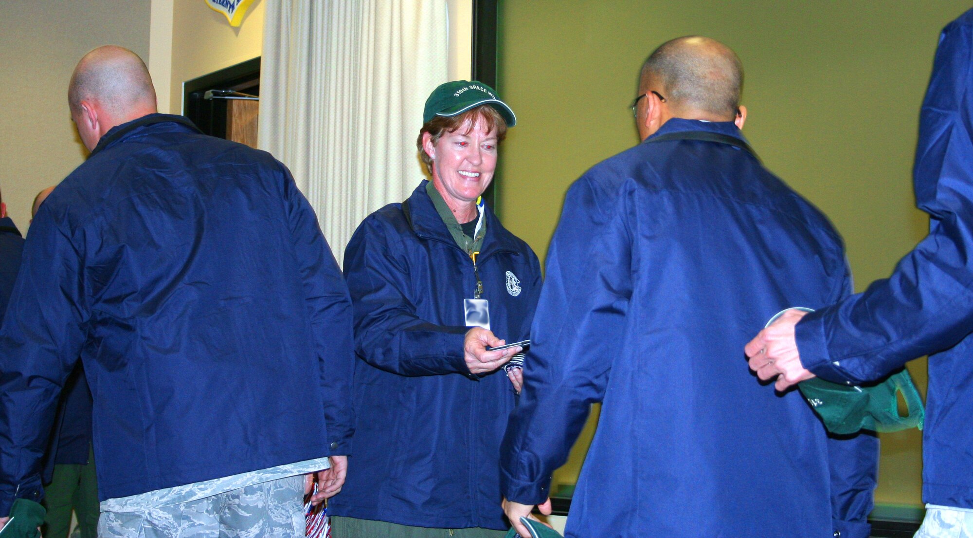 310th Space Wing commander Col. Karen A. Rizzuti presents the wing’s Guardian Challenge participants with official 310SW GC2010 patches at the pep rally May 2 at Schriever Air Force Base, Colo. (U.S. Air Force photo/Tech. Sgt. Scott P. Farley)