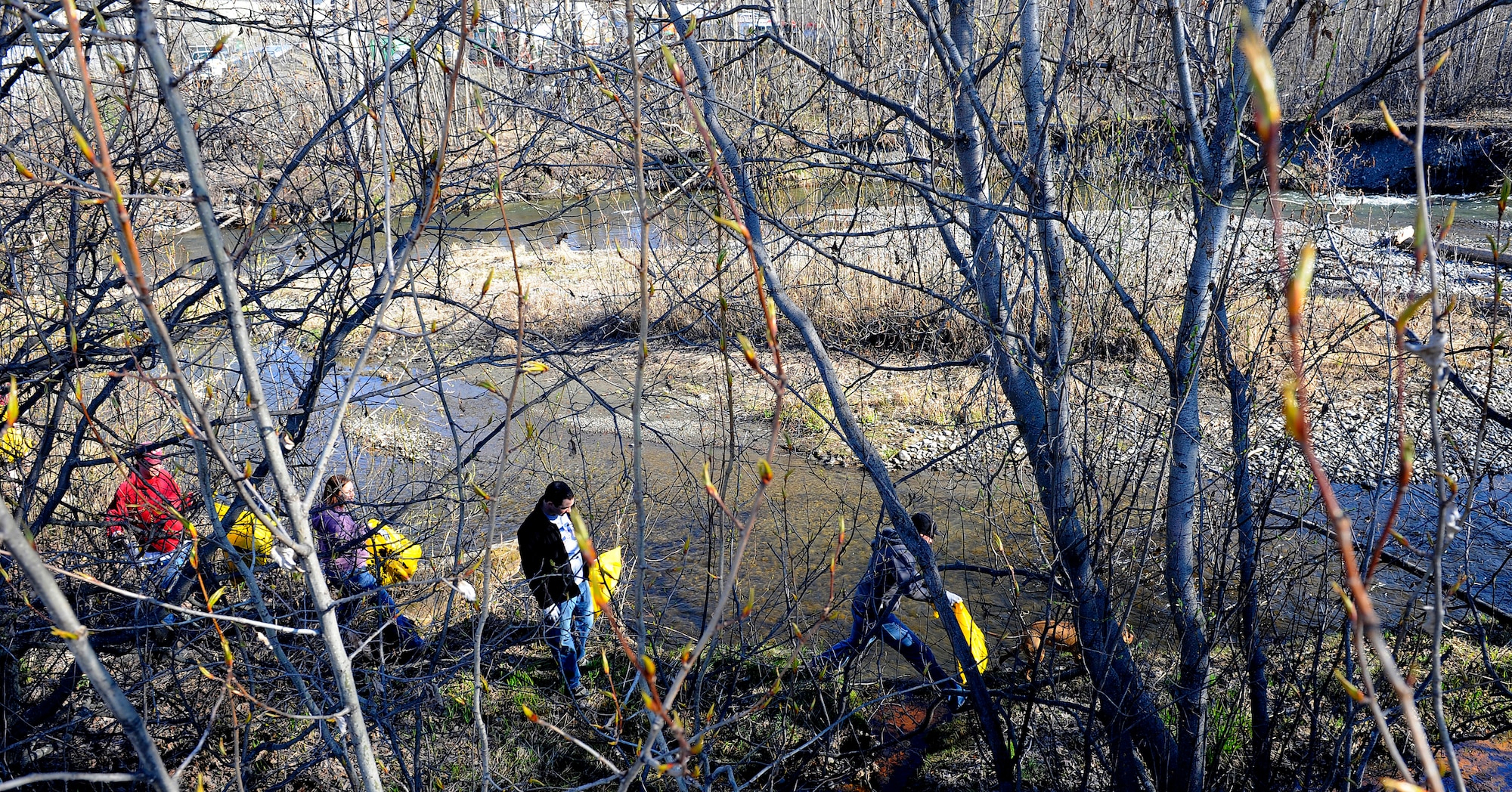 Airmen from the 525th Aircraft Maintenance Unit, Elmendorf Air Force Base, Alaska, pick up trash along Ship Creek during the 26th Annual Creek Cleanup May 8. The event was sponsored by The Anchorage Alaska Waterways and The Municipality of Anchorage. (Air Force photo by Staff Sgt. Brian Ferguson)