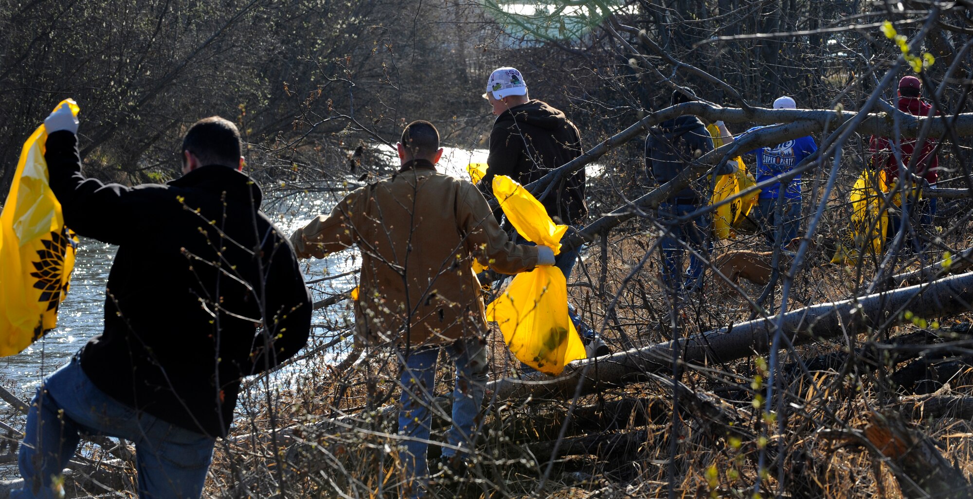 Airmen from the 525th Aircraft Maintenance Unit, Elmendorf Air Force Base, Alaska, pick up trash along Ship Creek during the 26th Annual Creek Cleanup May 8. The event was sponsored by The Anchorage Alaska Waterways and The Municipality of Anchorage. (Air Force photo by Staff Sgt. Brian Ferguson)