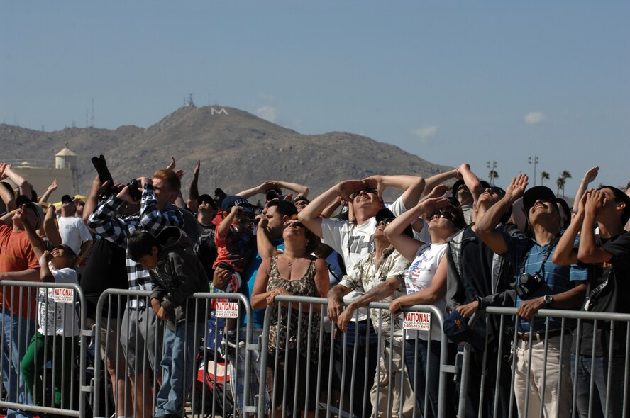 The crowd gazes at the skies, taking in the performances at the March Field AirFest, March Air Reserve Base, Calif., May 1, 2010. The AirFest is a bi-annual, two-day event featuring military and civilian aerial performances and static displays of modern and historic aircraft. (U.S. Air Force photo by Staff Sgt. Angel Gallardo/Released)