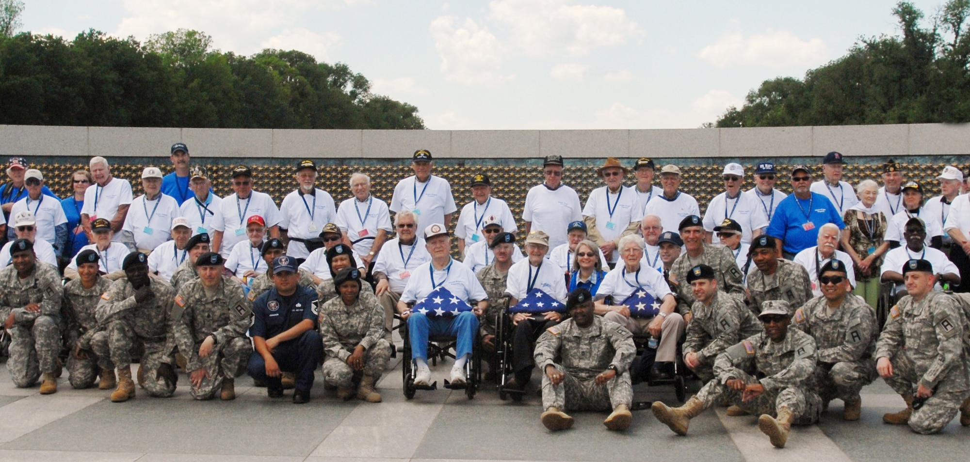Members of 3rd Battalion, 312th Training Support Regiment, 72nd Field Artillery Brigade pose with Honor Flight Veterans who gathered in  Fayette, Ga. to fly free of charge to the National World War II Memorial in Washington May 4. Honor Flight Network, a program conceived by Retired Air Force Captain Earl Morse, is a nonprofit organization. The goal of the program is to transport veterans to visit the memorials built to honor their service and sacrifices in World War II, Korea and Vietnam. (U.S. Army photo/1st Lt. Kevin Skindell)