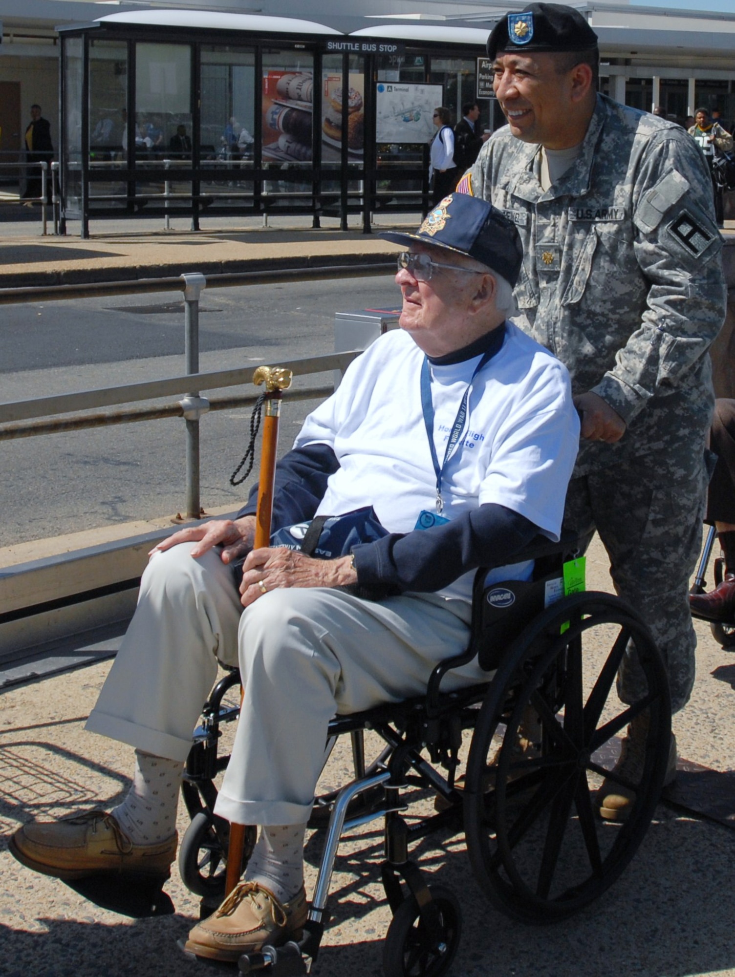 Maj. Alexander Jimenez, 3-312th Training Support Battalion, escorts Jack G. Rolfson from the terminal at Regan National Airport to awaiting transportation bound for the National World War II memorial in Washington May 4 as part of the annual Honor Flight. Honor Flight Network, a program conceived by Retired Air Force Capt. Earl Morse, is a non-profit organization. Its goal is to transport veterans free of charge to visit the memorials built to honor their service and sacrifices in World War II, Korea and Vietnam. (U.S. Army photo/1st Lt. Kevin Skindell)