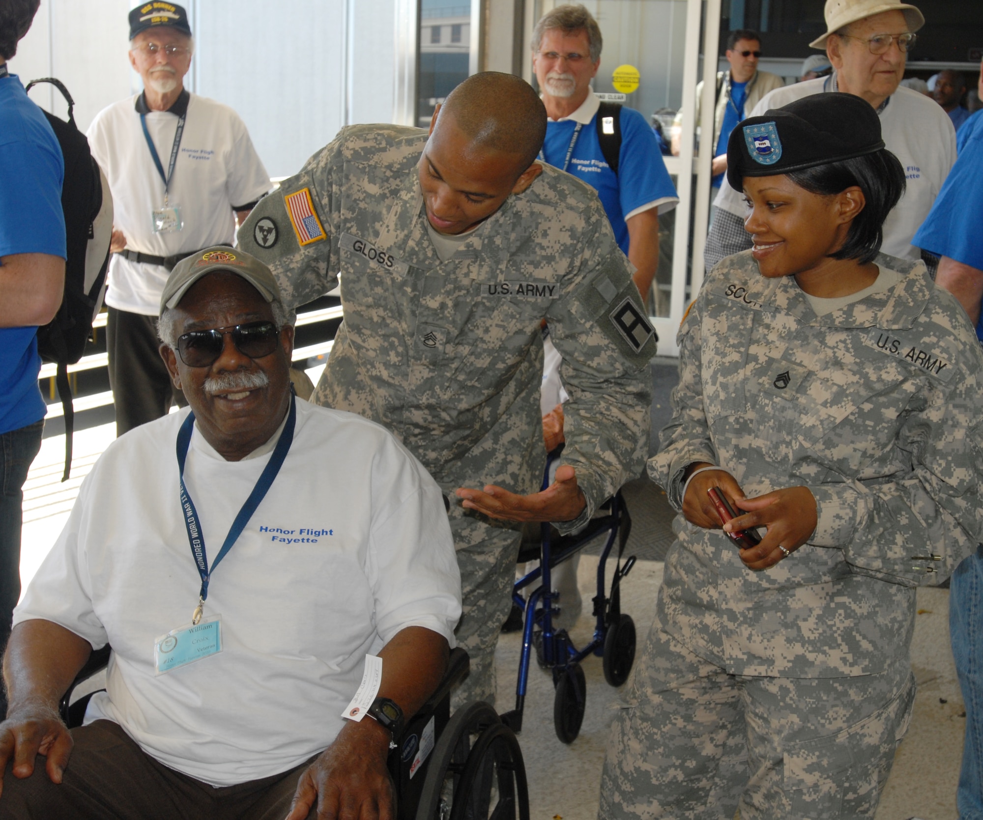 Sgt. 1st Class Guelmy Gloss and Staff Sgt. Miranda Scott, 3-312th Training Support Battalion, share a laugh with veteran William Croix as they make their way to the National World War II memorial in Washington May 4. The Soldiers participated in the annual Honor Flight that transports veterans, free-of-charge, to visit the foreign wars memorials in the nation’s capital. (U.S. Army photo/1st Lt. Kevin Skindell)