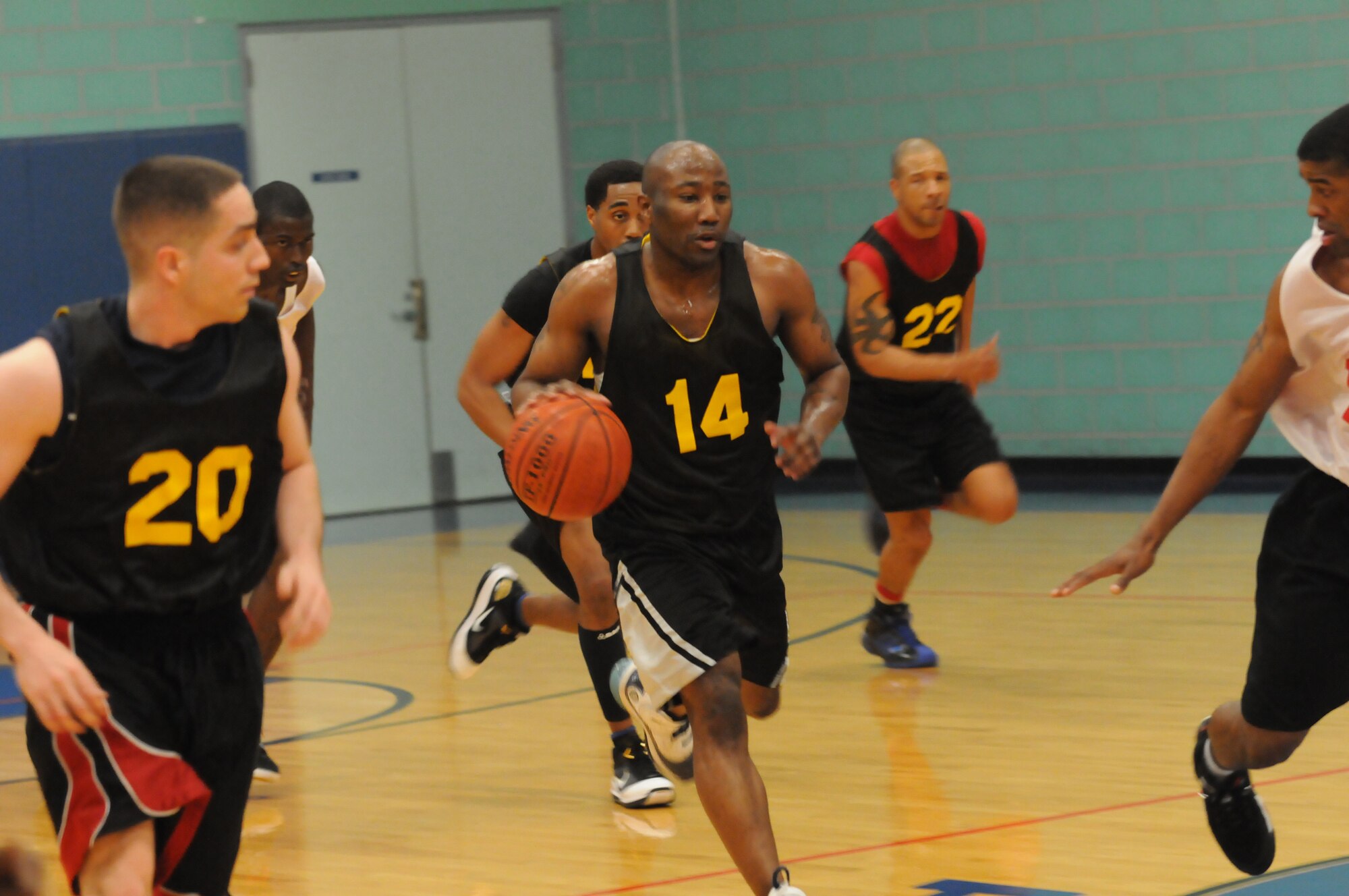 GOODFELLOW AIR FORCE BASE, Texas -- Players from the 17th Communications Squadron run the ball down the court during the Intramural Basketball Championship game, May 6, 2010. (U. S. Air Force photo/Airman 1st Class Clayton Lenhardt)