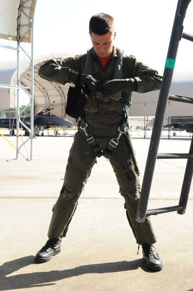 SEYMOUR JOHNSON AIR FORCE BASE, N.C. -- Capt. Dave Cochran secures his parachute harness before his flight during the turkey shoot competition here, May 7, 2010. The competition tested the ability of each of the four base fighter squadrons on generating an aircrew, taking to the sky and returning. Captain Cochran, 333rd Fighter Squadron pilot, hails from Clayton. (U. S. Air Force photo/Staff Sgt. Courtney Richardson)
