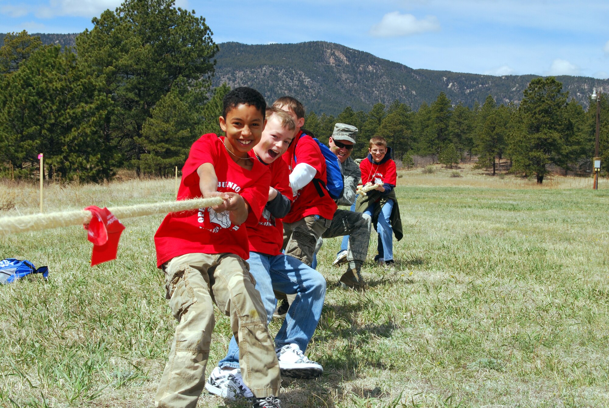 Fadio Fenner, Blandon Beeler, Luke Ryktarsyk, Chief Master Sgt. Thomas Young, Ethan Gunn and Matthew Mikovits give their all in a tug-of-war contest during Operation Junior Deployer May 1, 2010, at the U.S. Air Force Academy in Colorado. Chief Young is the 10th Force Support Squadron superintendent. (U.S. Air Force photo/Staff Sgt. Don Branum)
