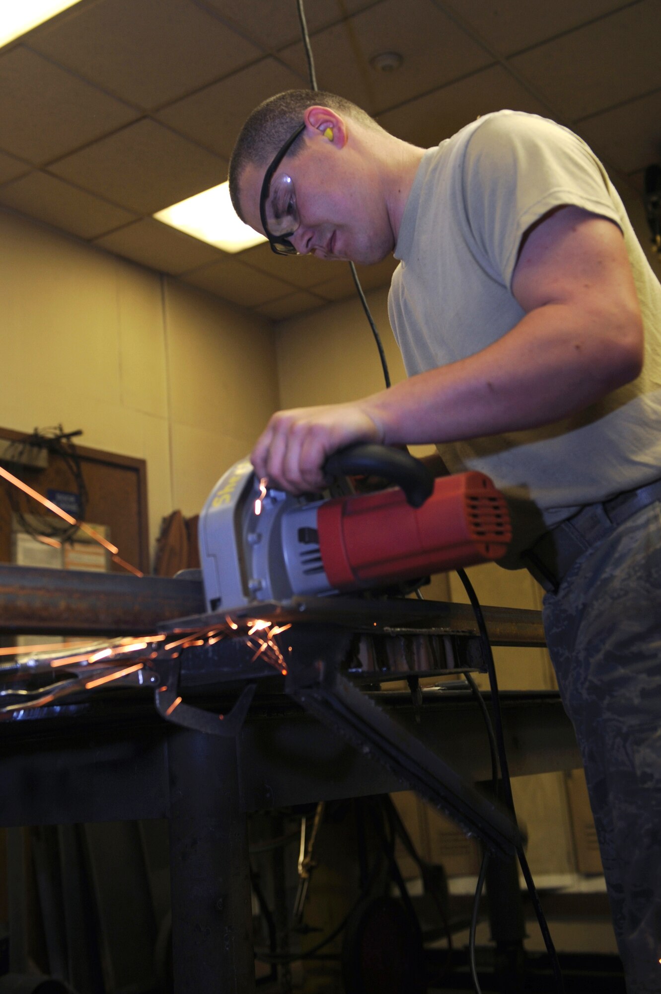 MINOT AIR FORCE BASE, N.D. -- Staff Sgt. Christopher Mercer, 5th Civil Engineer Squadron structural craftsman, saws off a portion of a shooting door here May 6.  The structures shop reshaped 20 doors to help with the remodeling of the base combat arms firing range. (U.S. Air Force photo by Tech. Sgt. Lee A. Osberry Jr.)