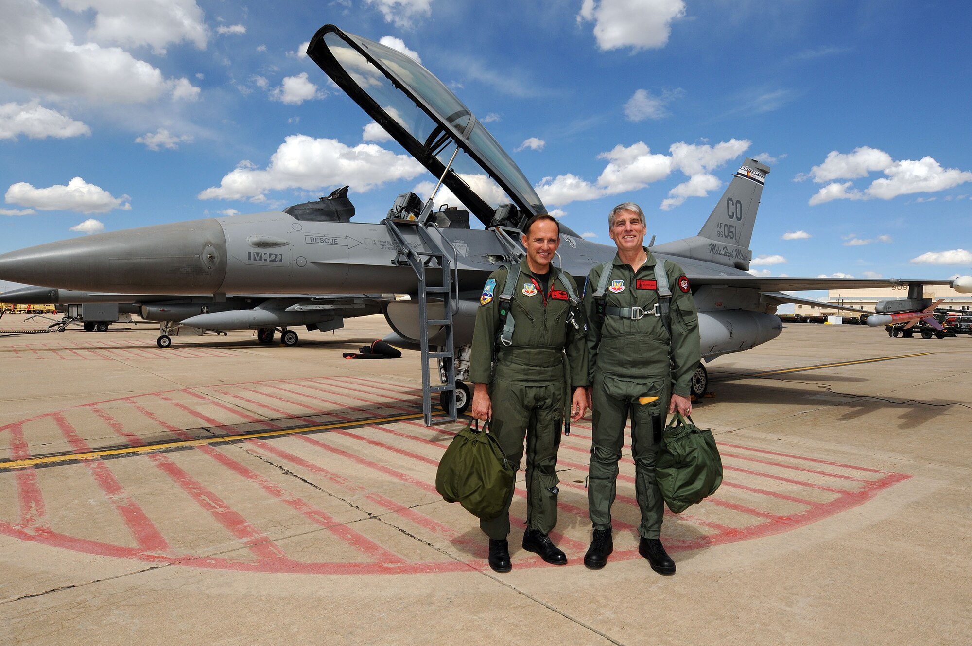 Colorado Senator Mark Udall and Brig. Gen. Trulan Eyre, 140th Wing Commander, pose for a photo prior to takeoff on Saturday, 1 May.  Mark Udall spent the day at Buckley Air Force Base with Colorado Guardsmen to further understand the Air National Guard's missions, people and weapons systems that operate in both state and federal capacities.
