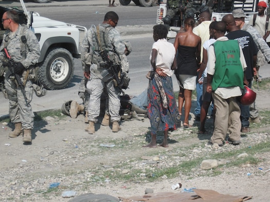 PORT-AU-PRINCE, Haiti -- Members of the 823rd Expeditionary Security Forces Squadron crowd around an injured pedestrian here May 7. Thanks to the quick response of Senior Airmen Alexander Parrilla, 823rd ESFS entry controller, the squadron was able to quickly respond and help save the woman’s life. (Contributed photo/RELEASED)