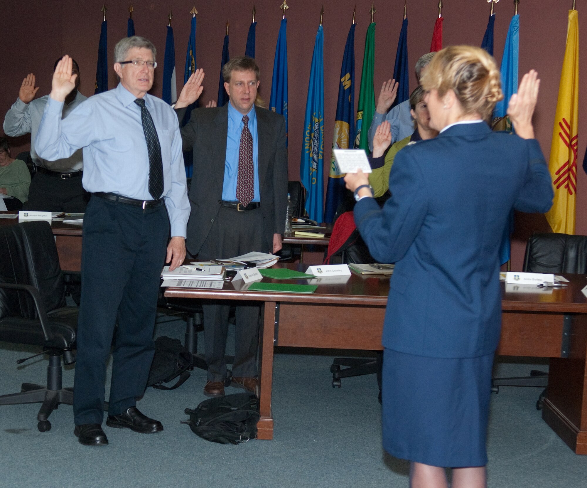 Col. Mary McRae, Electronic Systems Center chief of staff, swears in the latest Hanscom civilian employees during the orientation course Monday.  (U.S. Air Force photo by Rick Berry)