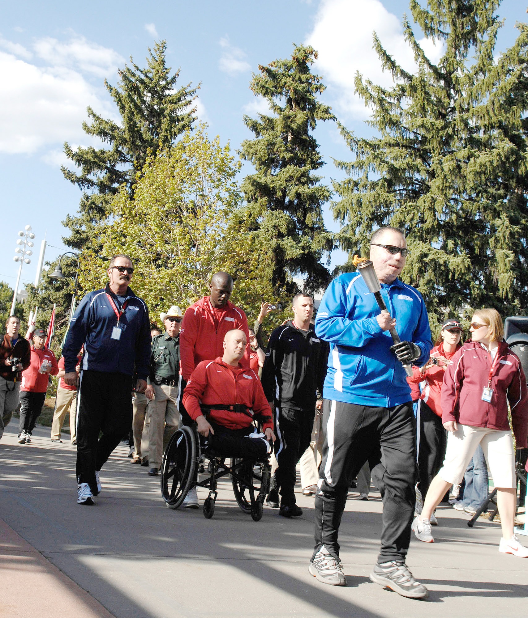 Tech. Sgt. Israel Del Toro carries the Warrior Games torch down Olympic Path for the inaugural Warrior Games May 10, 2010, at the U.S. Olympic Training Center in Colorado Springs, Colo. Sergeant Del Toro is one of some 200 disabled veterans participating in the Paralympic-style competition May 10 through 14. (Defense Department photo/Army Sgt. 1st Class Michael J. Carden)
