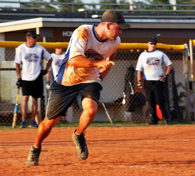 A player strides to first base during the 2010 Police Week softball tournament held at Eglin Air Force Base, Fla., May 8.  96th Security Forces Squadron won the tournament with a perfect record.  Proceeds raised by the tournament will go to a police officers' memorial.  (U.S. Air Force photo/Ashley M. Wright.)