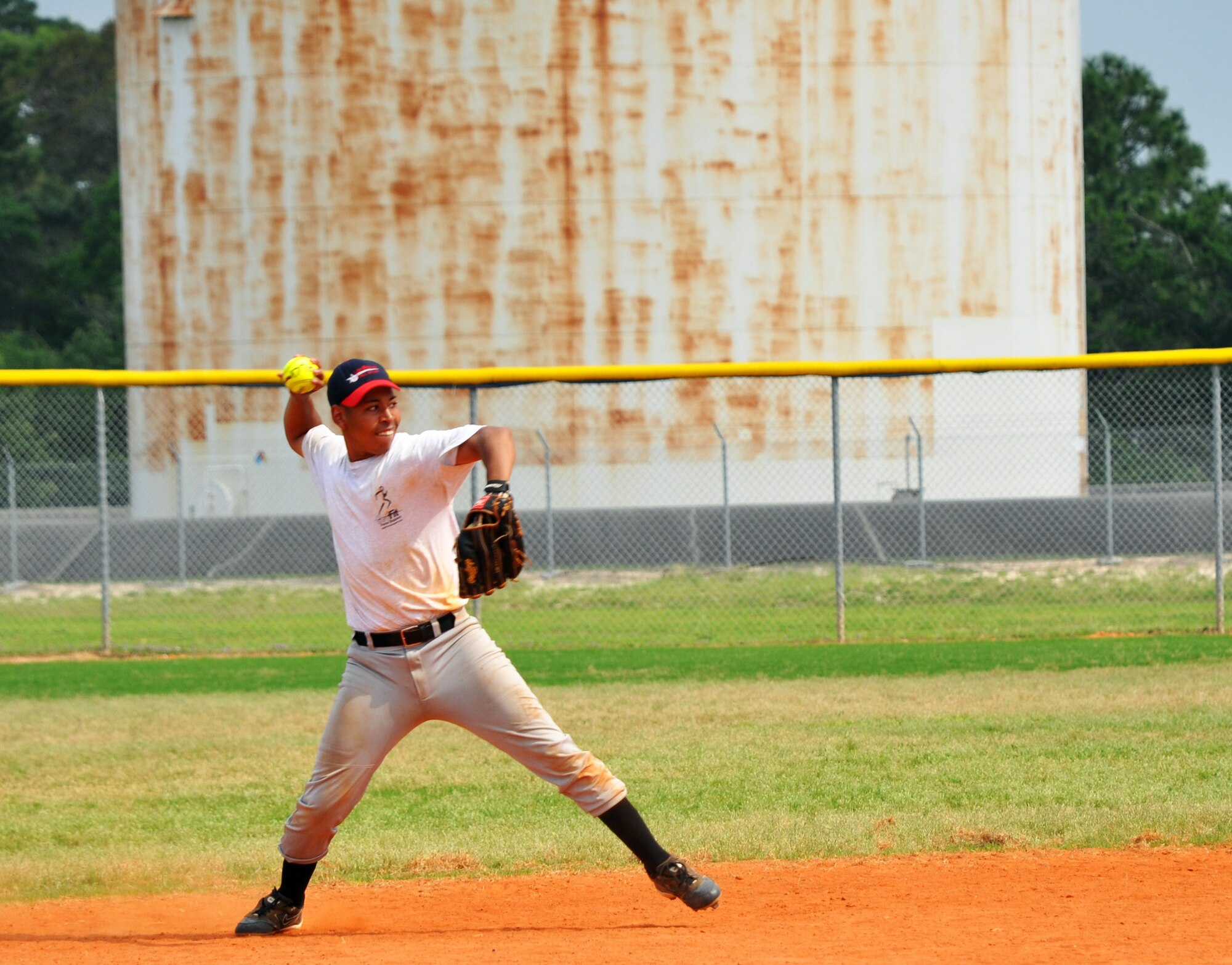 A player sends a throw to first base during the 2010 Police Week softball tournament held at Eglin Air Force Base, Fla., May 8.  96th Security Forces Squadron won the tournament with a perfect record.  Proceeds raised by the tournament will go to a police officers' memorial.  (U.S. Air Force photo/Ashley M. Wright.)