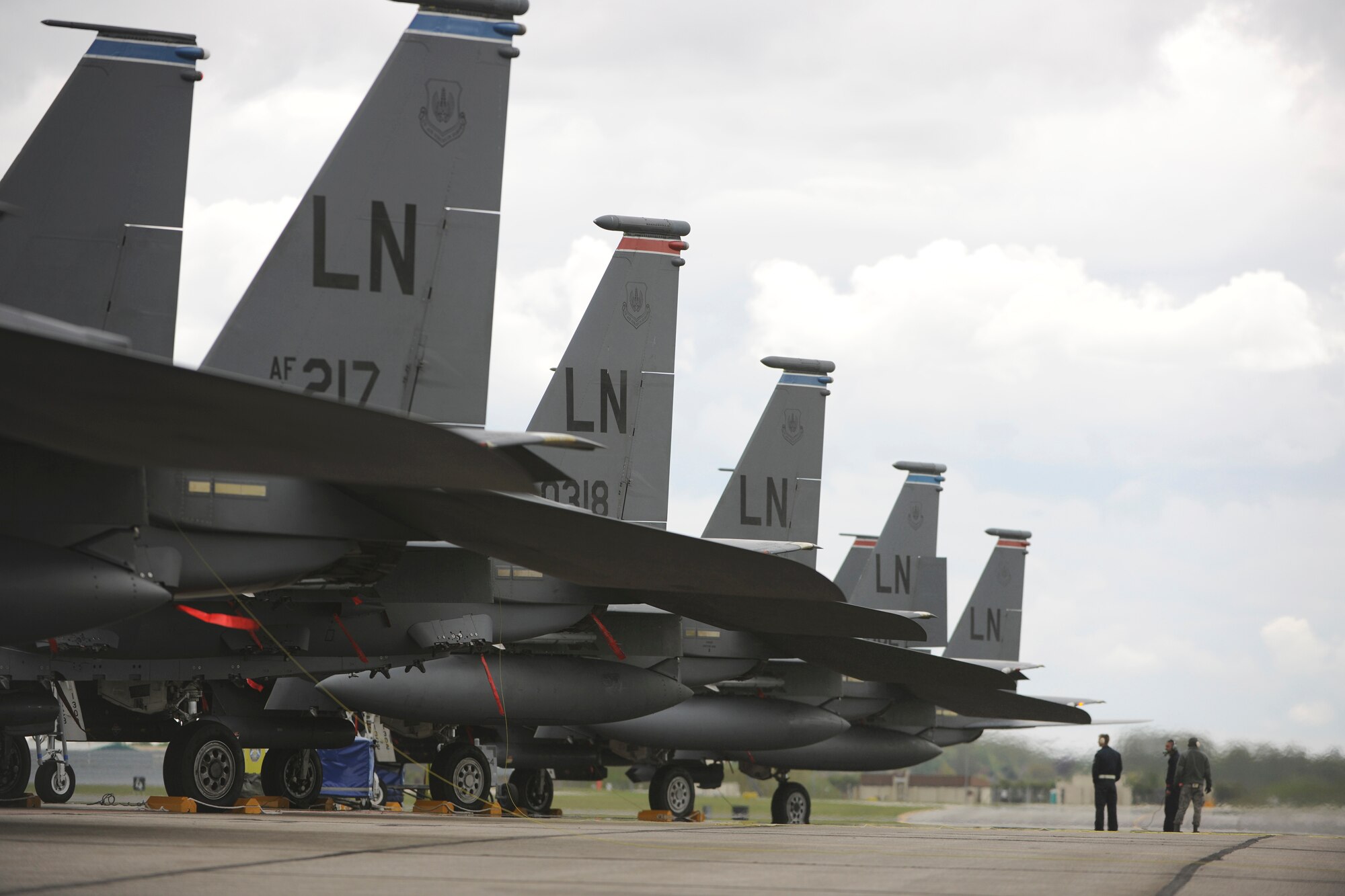 F-15 Eagle crew chiefs from the 48th Aircraft Maintenance squadron wait as a pair of F-15s warm up before takeoff, April 11, 2010. The crew chiefs and the aircraft will be operating out of RAF Mildenhall, England, for the next month, allowing the 48th Civil Engineering Squadron an opportunity to repair the runway at RAF Lakenheath. (U.S. Air Force photo by Tech. Sgt. Nathan Gallahan)