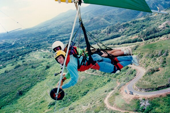 MAUI, Hawaii -- Craig Denton, front, hang glides in tandem with an instructor on Maui, Hawaii. Memorial Day 1994, Mr. Denton and his instructor crashed into the side of a mountain. Mr. Denton suffered two broken legs, a black eye, cuts across his face and a crushed cheek bone. Today, Mr. Denton, retired Air Force master sergeant and 21st Space Wing Public Affairs visual information technician, is still active in sports including mountain biking, snowboarding and hiking. He encourages Airmen to get in touch with their wing’s safety office or squadron safety representative to find out all there is to know about extreme sports before trying them. (Photo courtesy Craig Denton)