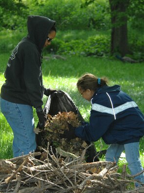 OFFUTT AIR FORCE BASE, Neb. -- Staff Sgt. Octavia Savage, 55th Medical Support Squadron, and her daughter Savannah Hall, pick up leaves and debris at the Henry Doorly Zoo in Omaha, Neb., May 8 during the zoo's annual clean up day. The mother and daughter pair were part of a large group from Offutt who volunteered to clean the zoo. U.S. Air Force photo by Delanie Stafford
