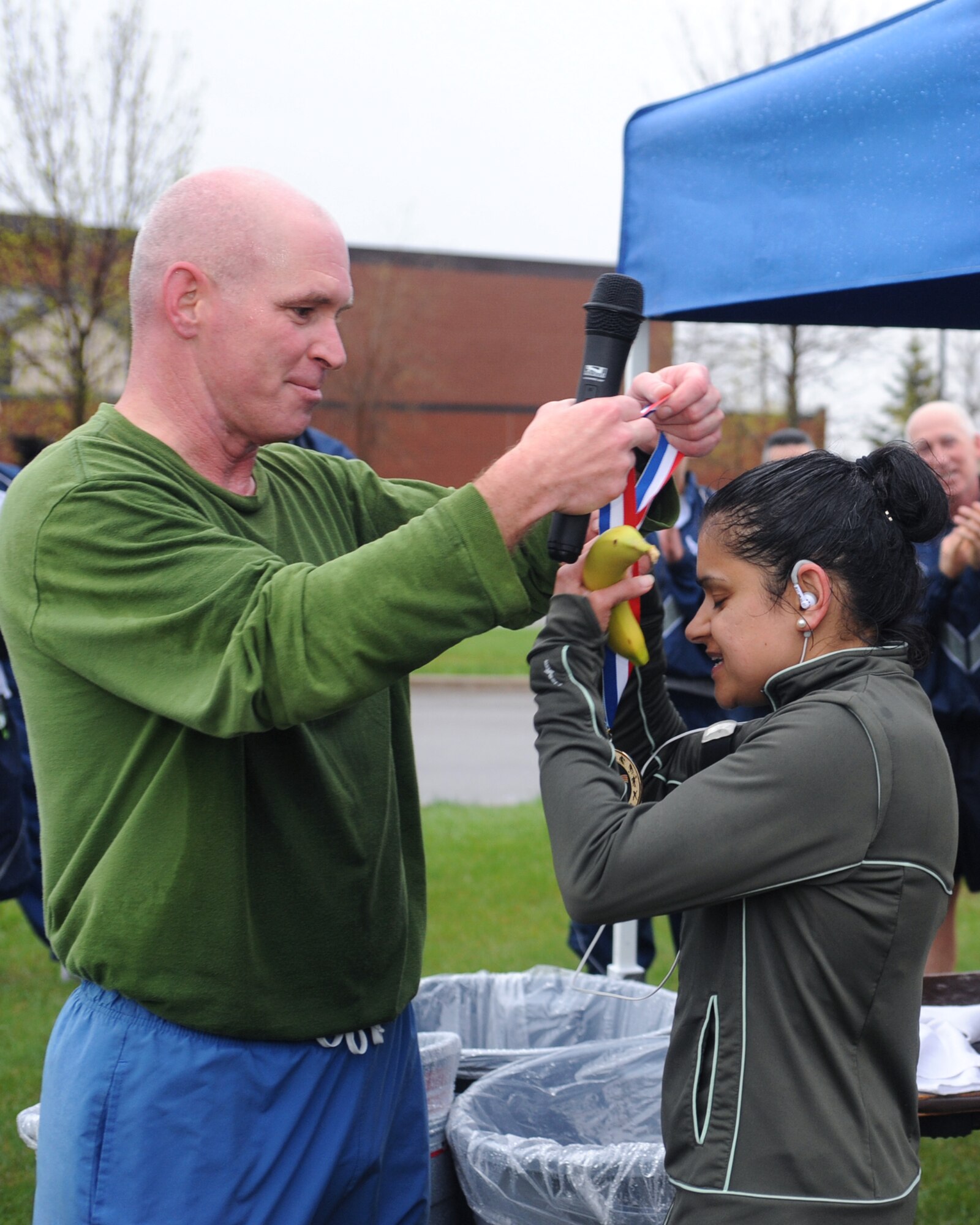 Col.  John Quinn, 319th Air Refueling Wing vice-commander, presents the first place medal for the female participants to Capt. Aarti Puri, 319 ARW, May 5 on Grand Forks Air Force Base, N.D.  Captain Puri participated in the Cinco de Mayo 5K run that was held to promote fitness. (U.S. Air Force photo by Airman 1st Class Amber Price)