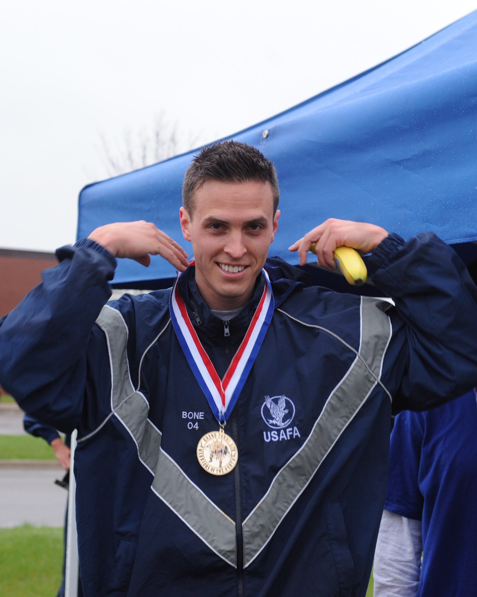 Capt. John Bone, 319th Air Refueling Wing, positions the first place medal around his neck that he won for participating in the Cinco de Mayo 5K run May 5 on Grand Forks Air Force Base, N.D. The run was held to promote fitness.  (U.S. Air Force photo by Airman 1st Class Amber Price)