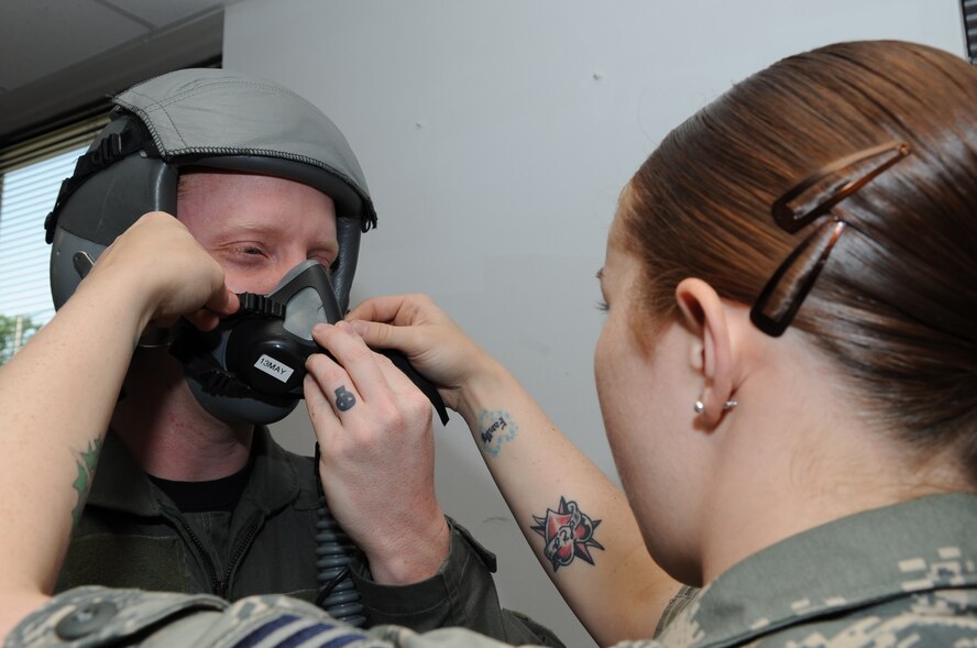 SEYMOUR JOHNSON AIR FORCE BASE, N.C. -- Senior Airman Emily Bertini adjusts a mask on Staff Sgt. Johnathan Bertini during an aircrew flight equipment competition here, May 6, 2010. During the competition, aircrew technicians had to fit aircrew members with flight gear and check masks for air leaks. Airman Bertini and Sergeant Bertini are aircrew flight equipment technicians from the 4th Operations Support Squadron. Airman Bertini hails from Springtown, Texas, and Sergeant Bertini is from Buffalo, N.Y. (U.S. Air Force photo/Staff Sgt. Courtney Richardson)