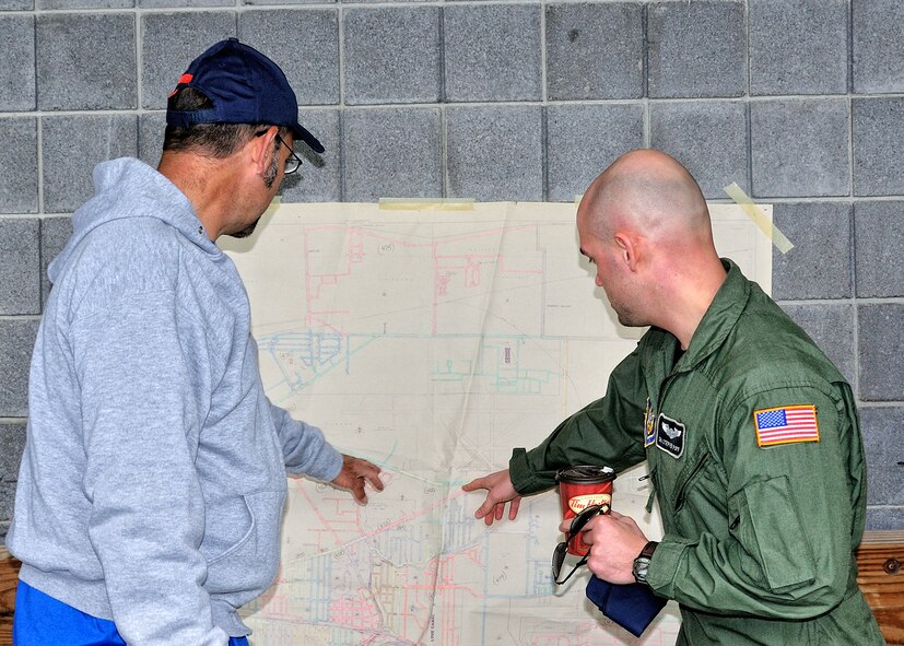 Senior Airman Stephen Puff, of the 914th AES and Mr. Walt Wrazin  a Niagara Falls letter carrier and co-chairman of the local drive plan the route for the 18th annual Letter Carriers Food Drive, May 8, 2010, Niagara Falls NY. Volunteers worked with letter carriers to collect food donated by families on their routes. All food collected was distributed to local food pantries. (U.S. Air Force photo by Staff Sgt. Joseph McKee)