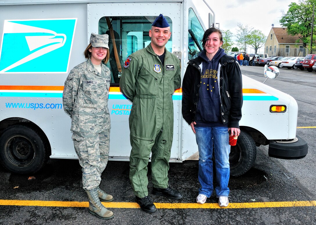Senior Airman Stephen Puff, Airman Kristie Durst both of the 914th AES and Ms. Kristen Sommer volunteer to help letter carriers collect food during the 18th annual Letter Carriers Food Drive, May 8, 2010, Niagara Falls NY. Volunteers worked with letter carriers to collect food donated by families on their routes. All food collected was distributed to local food pantries. (U.S. Air Force photo by Staff Sgt. Joseph McKee)