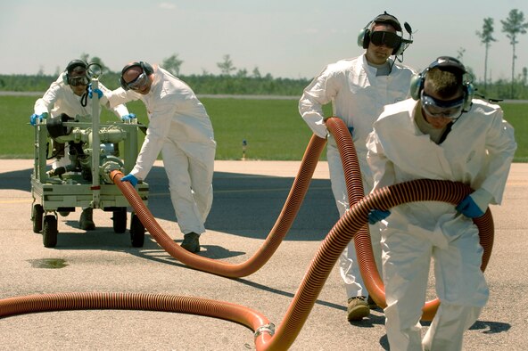 A team of Airmen refill a chemical dispersing C-130 Hercules May 4, 2010, at Stennis International Airport in Kiln, Miss. Members of the Air Force Reserve Command's 910th Airlift Wing are in Mississippi to assist with the Deepwater Horizon oil spill. The team of aerial spray aircraft maintainers are from the 910th Aircraft Maintenance Squadron at Youngstown-Warren Air Reserve Station, Ohio. (U.S. Air Force photo/Tech. Sgt. Adrian Cadiz)