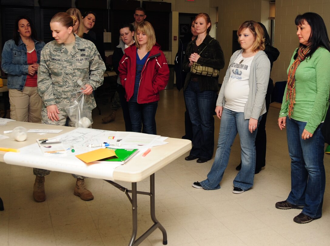 ELLSWORTH AIR FORCE BASE, S.D. -- Staff Sgt. Jessica Aadalen, 28th Civil Engineer Squadron emergency management technician, gives a demonstration about hazardous chemical disposal for spouse day, May 7.  Spouses from every squadron were encouraged to see what their husband or wife does in the Air Force. (U.S. Air Force/photo Air man 1st Class Anthony Sanchelli)
