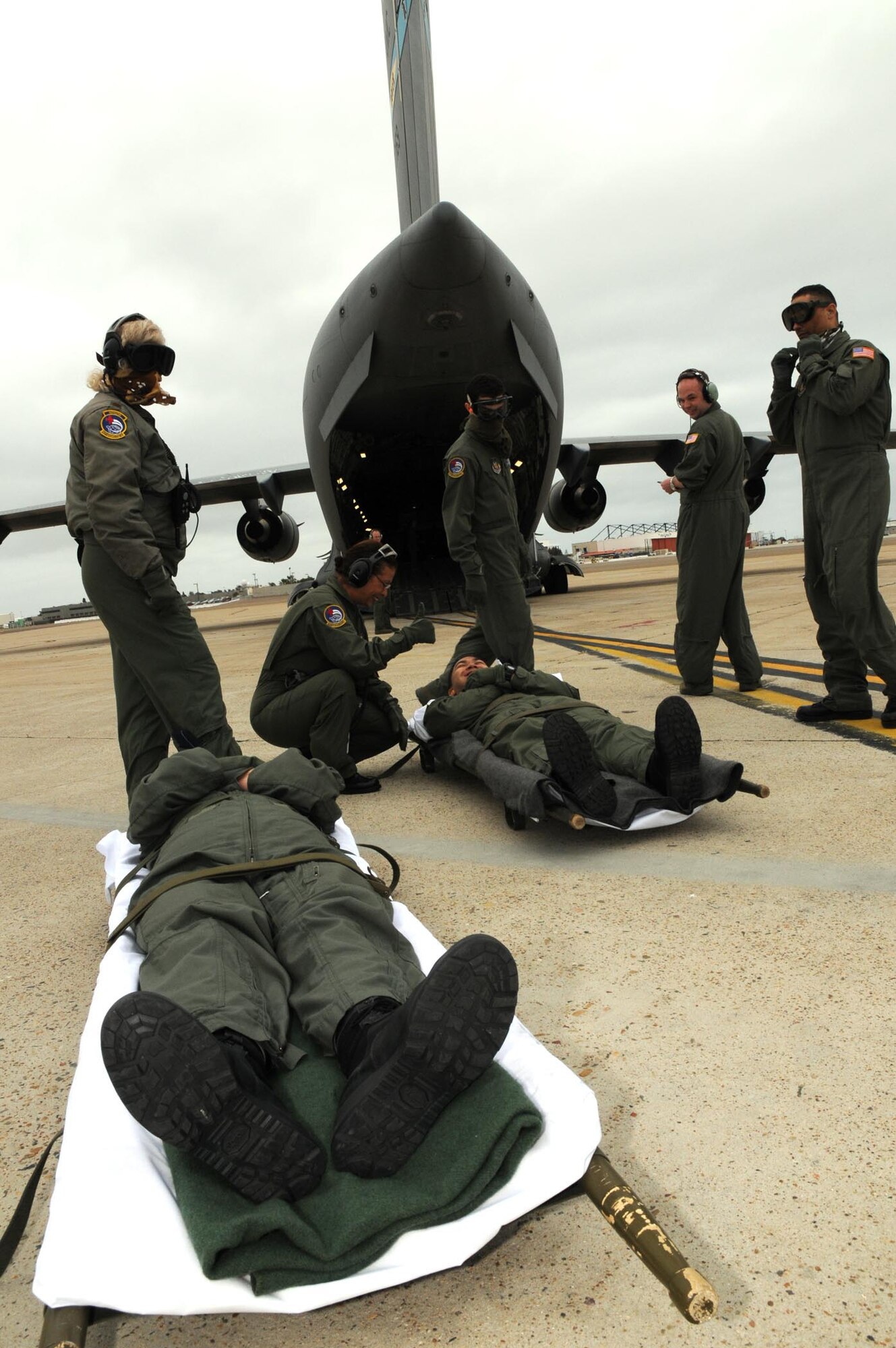 Members of the 452nd Aeromedical Evacuation Squadron, March Air Reserve Base, Calif., unload a "patients" off a C-17 Globemaster III during an aeromedical evacuation exercise May 7-9. The 326th Airlift Squadron provided the airlift for the medical team, allowing them to train in a real-world environment. (U.S. Air Force photo/Senior Airman Andria J. Allmond) 