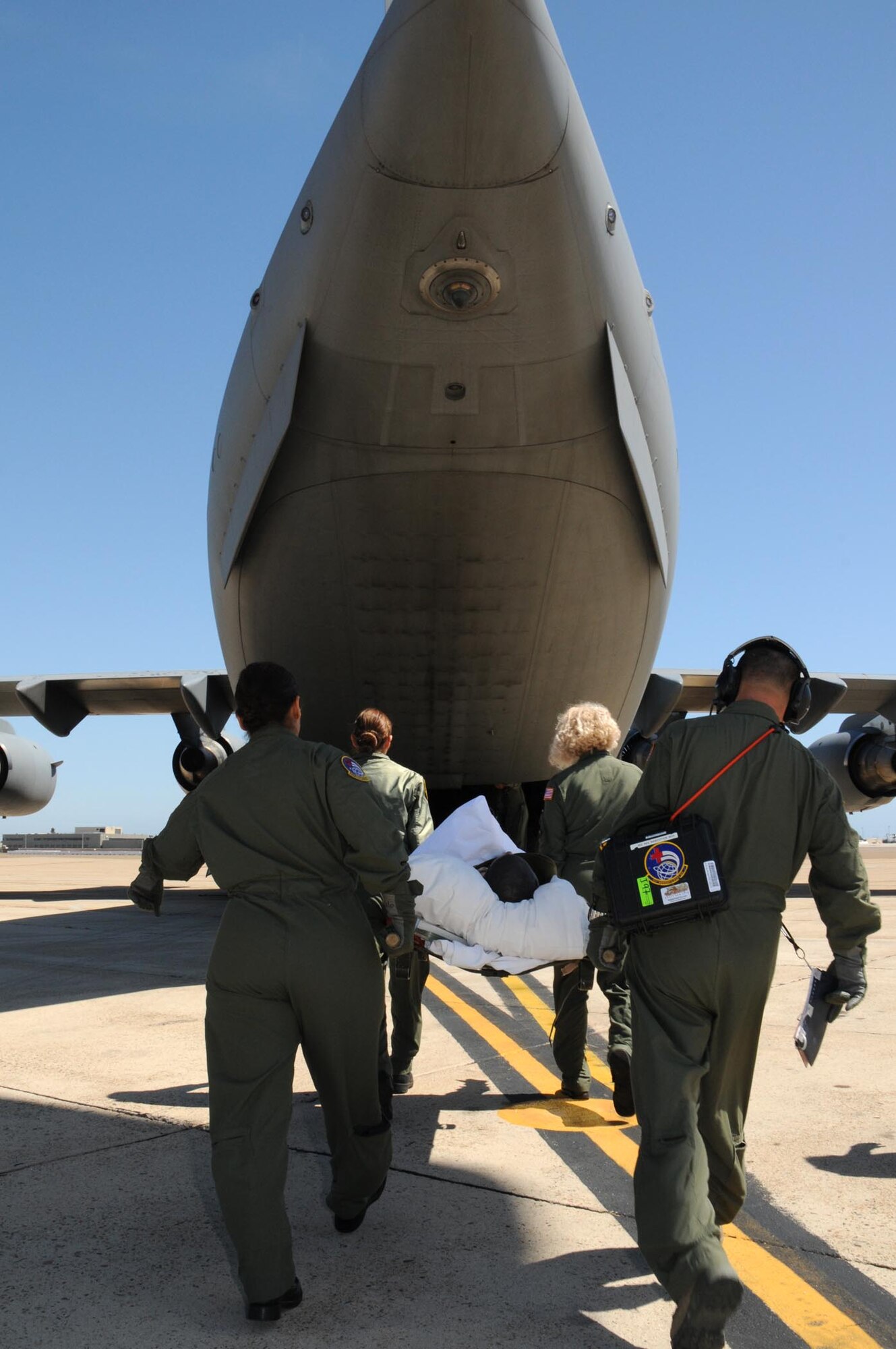 Members of the 452nd Aeromedical Evacuation Squadron, March Air Force Base, Calif., load a "patient" onto a C-17 Globemaster III during an aeromedical evacuation exercise May 7-9. The 326th Airlift Squadron provided the airlift for the medical team, allowing them to train in a real-world environment. (U.S. Air Force photo/Senior Airman Andria J. Allmond) 