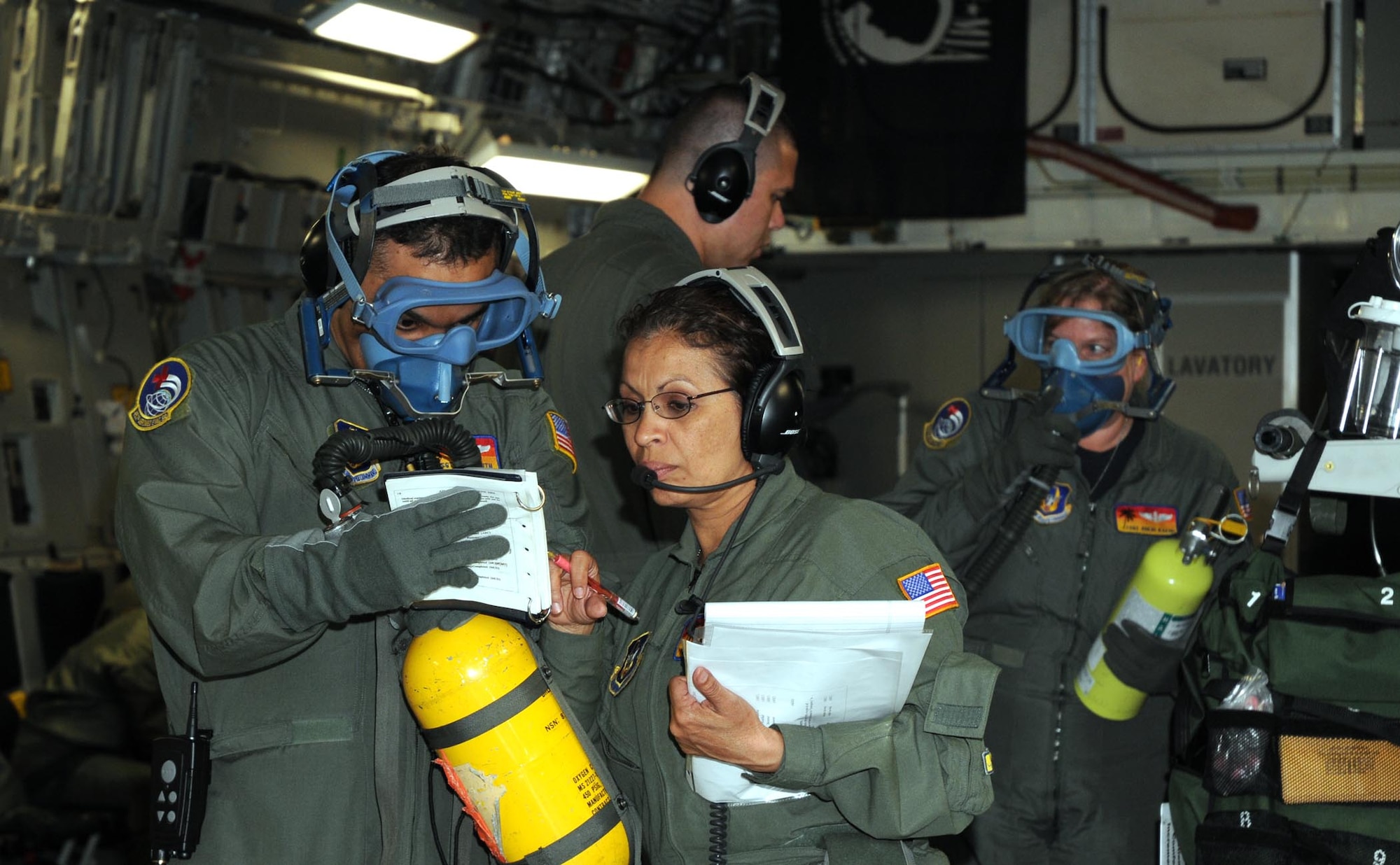 Members of the 452nd Aeromedical Evacuation Squadron, March Air Reserve Base, Calif., simulate an in-flight fire in the cargo area of a C-17 Globemaster III during an aeromedical evacuation exercise May 7-9. Supported by the 326th Airlift Squadron, the medical team trained for emergencies dealing with both patient care as well as aircraft-related incidences. (U.S. Air Force photo/Senior Airman Andria J. Allmond) 
