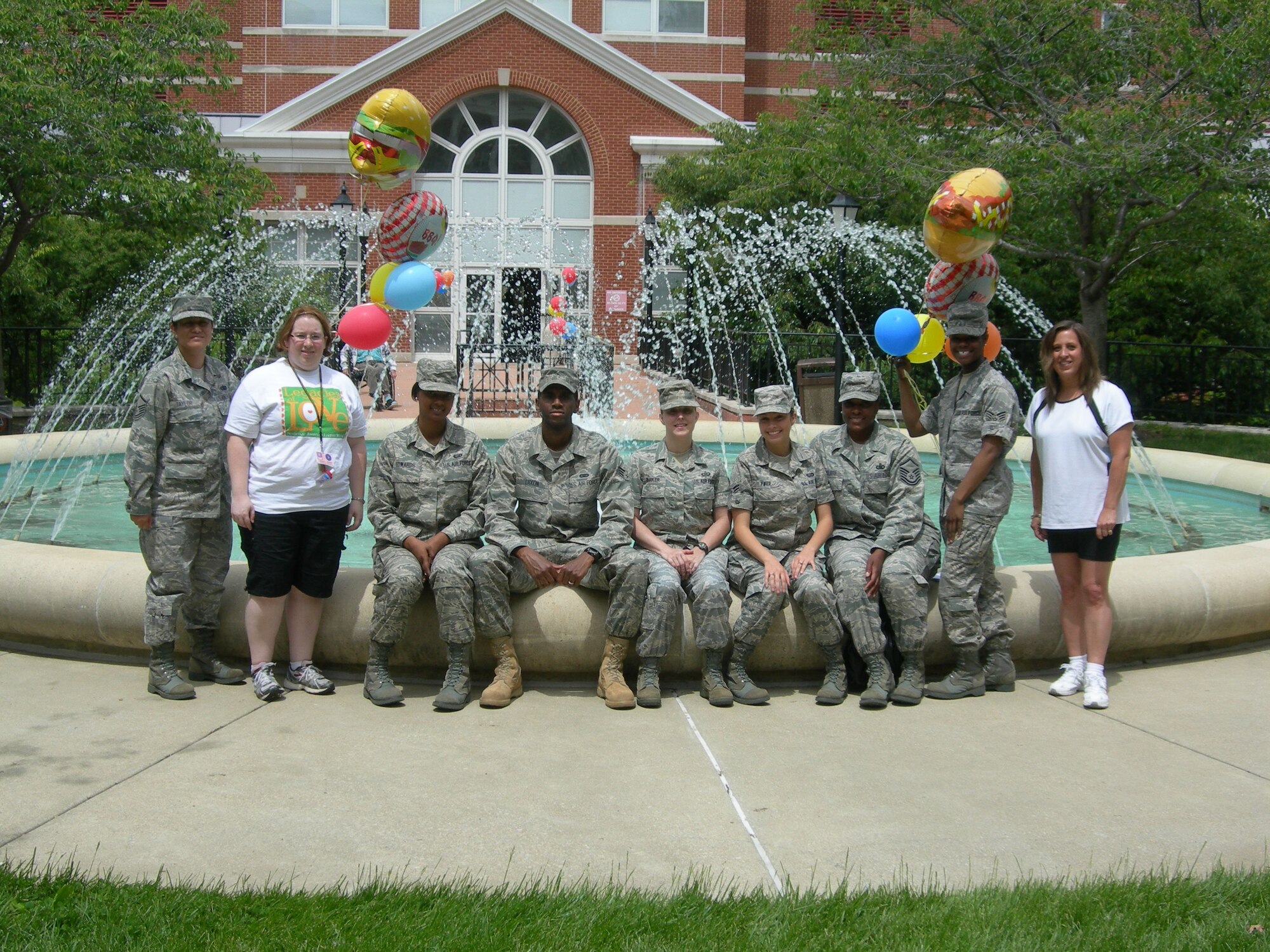 Air Force District of Washington volunteers (left to right) Master Sgt. Rica Taylor, Ms. Amanda Jensema, Armed Forces Retirement Home Recreation Therapist, Senior Airman Sheena Edwards, Personnel Specialist, Senior Airman Carlton Dixon, Knowledge Operator, Staff Sgt. Stacey Barker, NCOIC Comand and Control, Airman 1st Class Mary Fifer, Personnel Specialist, Master Sgt. Tonette Holman, NCOIC Supply Chain Management Divison, Senior Airman Tiffany Miles, Knowledge Operator and Ms. Carol Mitchell, Armed Forces Retirement Home Recreation Therapist pose for a group photo after the May Cookout held at the Armed Forces Retirement Home May 7, 2010. (U.S. photo by Aletha Frost)