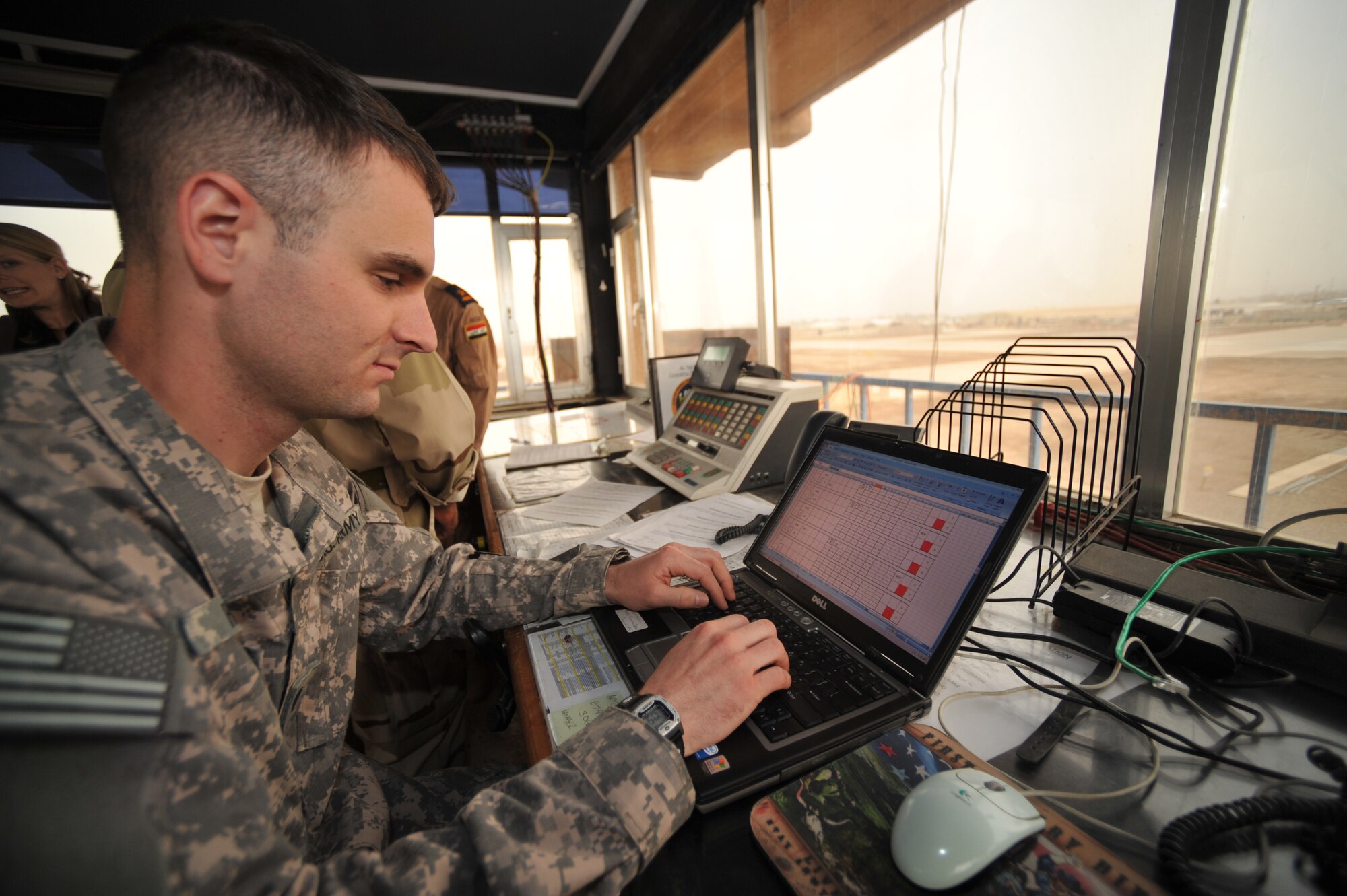 U.S. Army Spc. Cyrus Haines types air-traffic notes onto a laptop at Camp Taji, Iraq, April 17, 2010.  Spc. Haines is assigned to 1st Infantry, 2nd Battalion, 1st Division Fox Company, Combat Aviation Brigade.  (U.S. Air Force photo/Staff Sgt Quinton Russ/released)