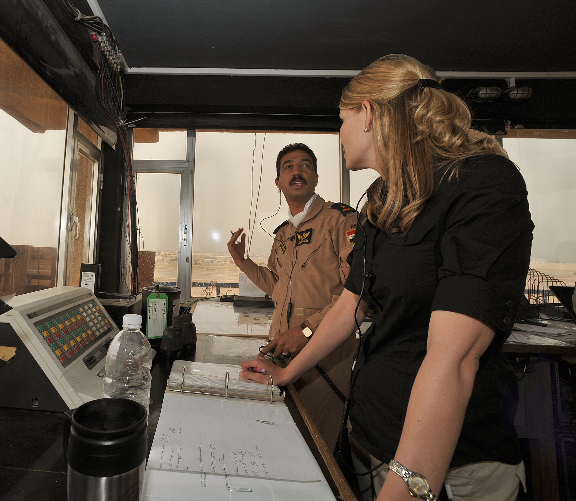 Air Traffic Control Instructor Ms. Patsy Thomas talks with Iraqi Air Force 2nd Lt. Shorsh Abdillah about tower rules at Camp Taji, Iraq, April 17, 2010.  The Iraqi Training and Advisory Mission is in the process of transferring all operations to the Iraqi military for the U.S. draw down.  Ms. Thomas is a member of the Washington Construct Group and is part of the transition team to assist in instructing future Iraqi air traffic controllers.  (U.S. Air Force photo/Staff Sgt Quinton Russ/released)