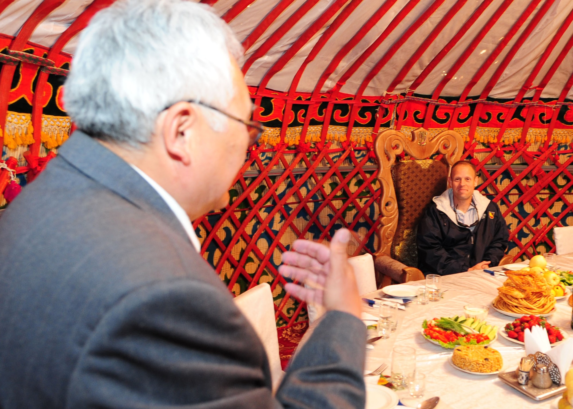 Toktobek Sapiynaov, host of the Kyrgyz traditional hunter's barbeque, addresses Col. Blaine Holt, director of the Transit Center at Manas, prior to beginning the feast.  Airmen from the Transit Center were invited to attend where they enjoyed a variety of traditional food. (U.S. Air Force photo/ Senior Airman Nichelle Anderson/ released)