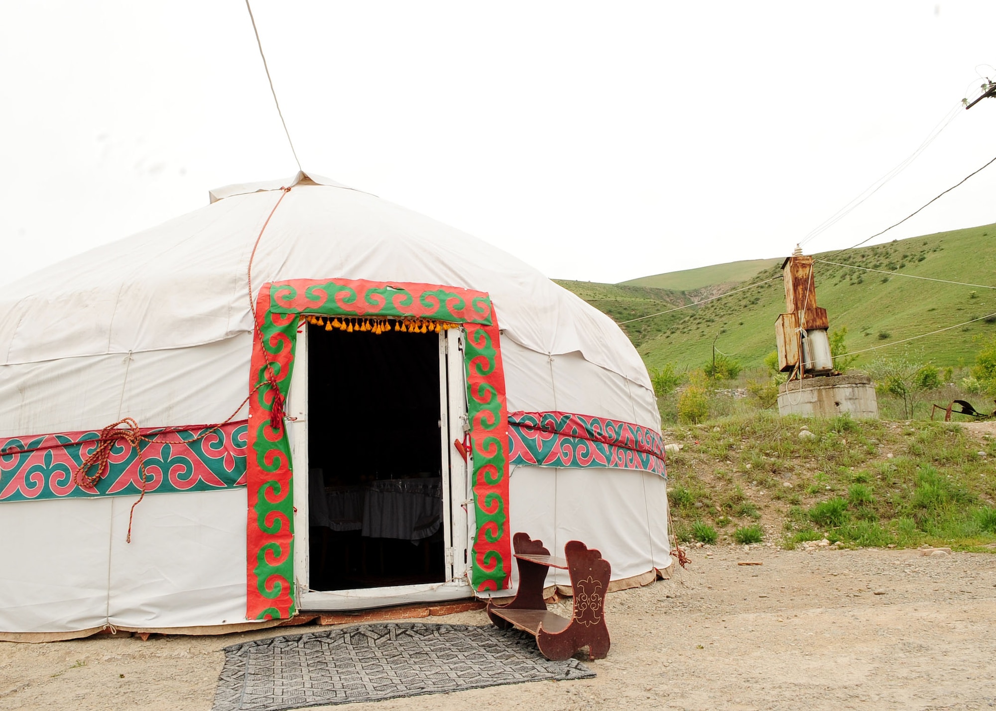 A yurt, the traditional Kyrgyz nomadic structure, sits at the base of a hill in Chong-Aryk near Bishkek, Kyrgyzstan, May 6, 2010. The yurt is a multi-functional, portable home consisting of a wooden structure with felt covers.  A little stove, used for cooking and heating the room, is usually found in the center of the yurt. (U.S. Air Force photo/ Senior Airman Nichelle Anderson/ released)