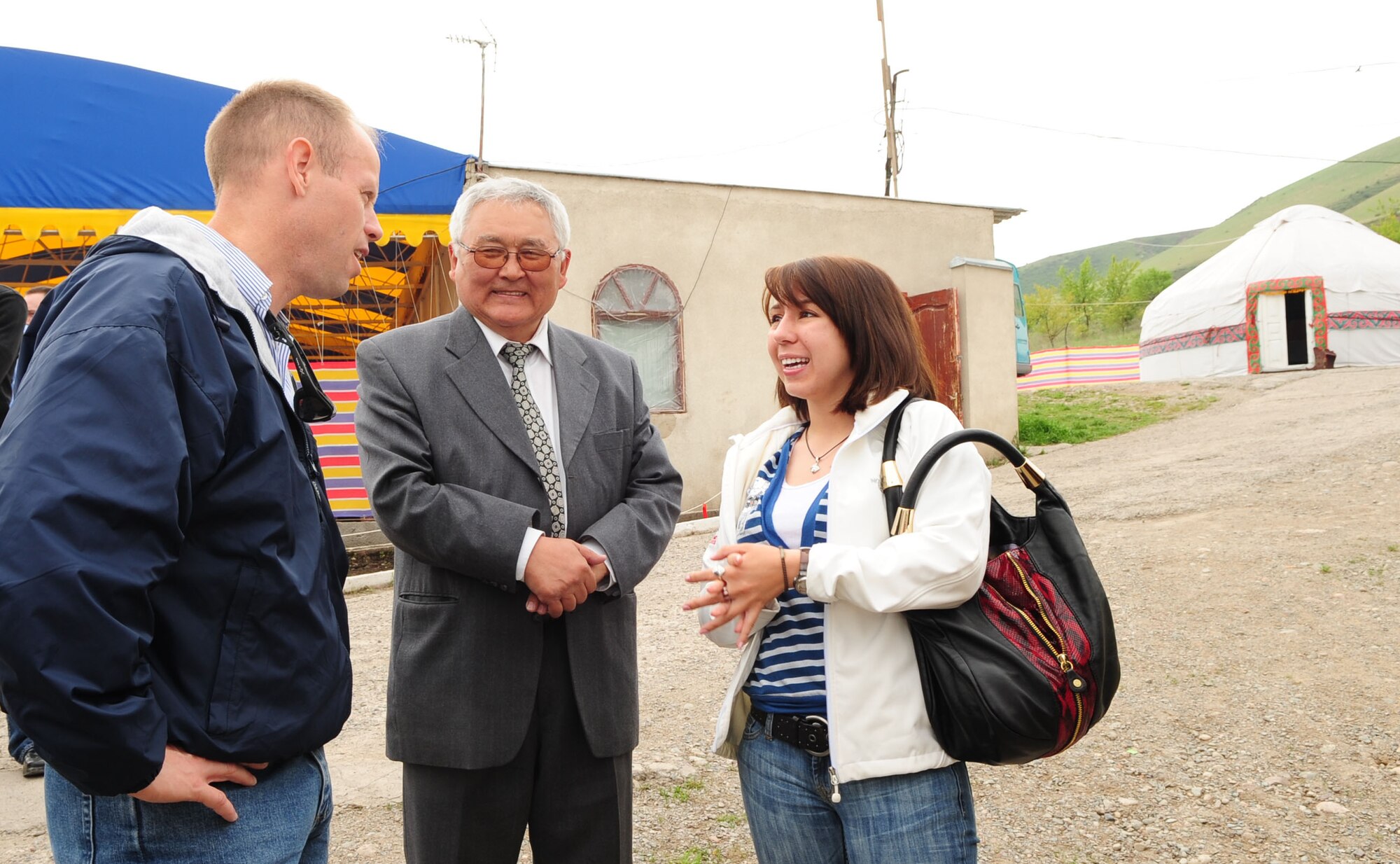 Col. Blaine Holt, director of the Transit Center at Manas, speaks to Toktobek Sapiynaov through Senior Airman Maria Gates, 376th Air Expeditionary Wing translator, at Chong-Aryk near Bishkek, Kyrgyzstan, May 6, 2010. (U.S. Air Force photo/ Senior Airman Nichelle Anderson/ released)