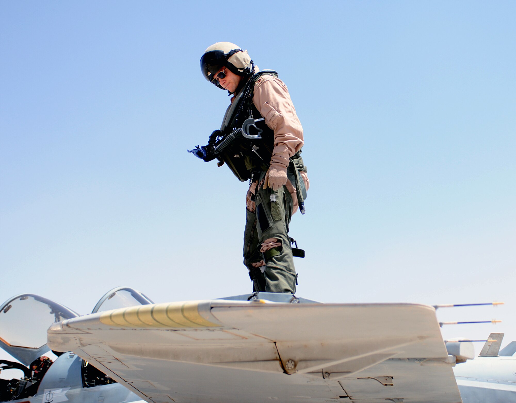 Navy Major Matthew Boque, a mission commander with the VAQ133 Electronic Attack Squadron, conducts a pre-flight inspection on the wing of an A6B-Prowler prior to a mission launch at Al Asad Airfield, Iraq, April 29, 2010. Major Boque and his shipmates are one of three Navy land-based squadrons currently flying the Prowler with Air Force Electronic Warfare Officers. The joint warfighters are conducting aerial overwatch operations for convoys at Al Asad. The AF officers are assigned to the 366th Fighter Wing at Mountain Home Air Force Base, Idaho, and work with their counterparts at Naval Air Station Whidbey Island, Wash., in the 388th Electronic Combat Squadron.   (U.S. Air Force photo/Master Sgt. Linda C. Miller/Released)