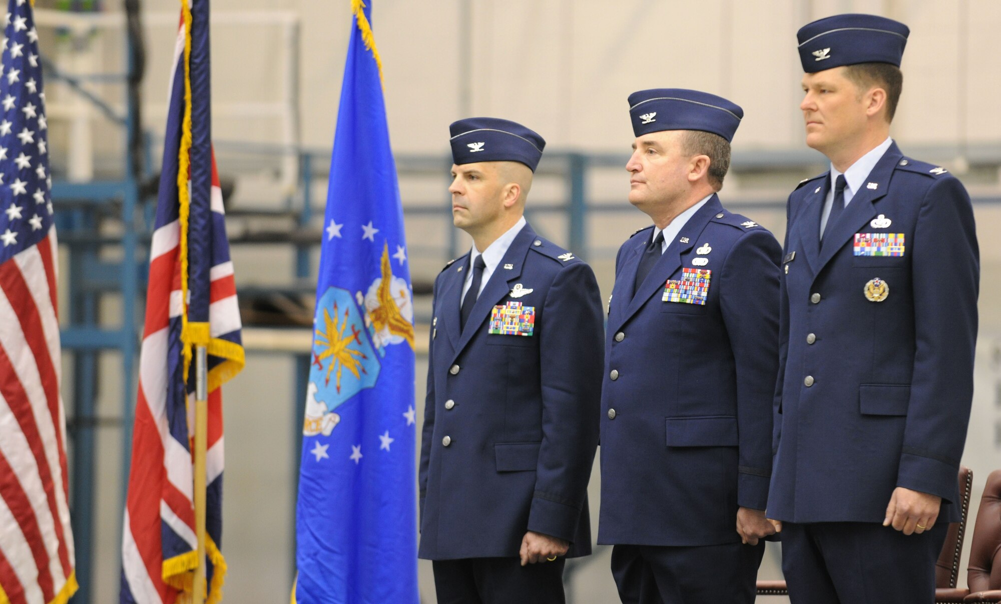 RAF MILDENHALL, England – Col. Chad Manske, 100th Air Refueling Wing commander (left), presides over the 100th Mission Support Group Change of Command Ceremony while Col. Jeffery Bateman (center) relinquishes command to Col. David Doe in hangar 814 May 7. (U.S. Air Force photo/ Staff Sgt. Jerry Fleshman) 