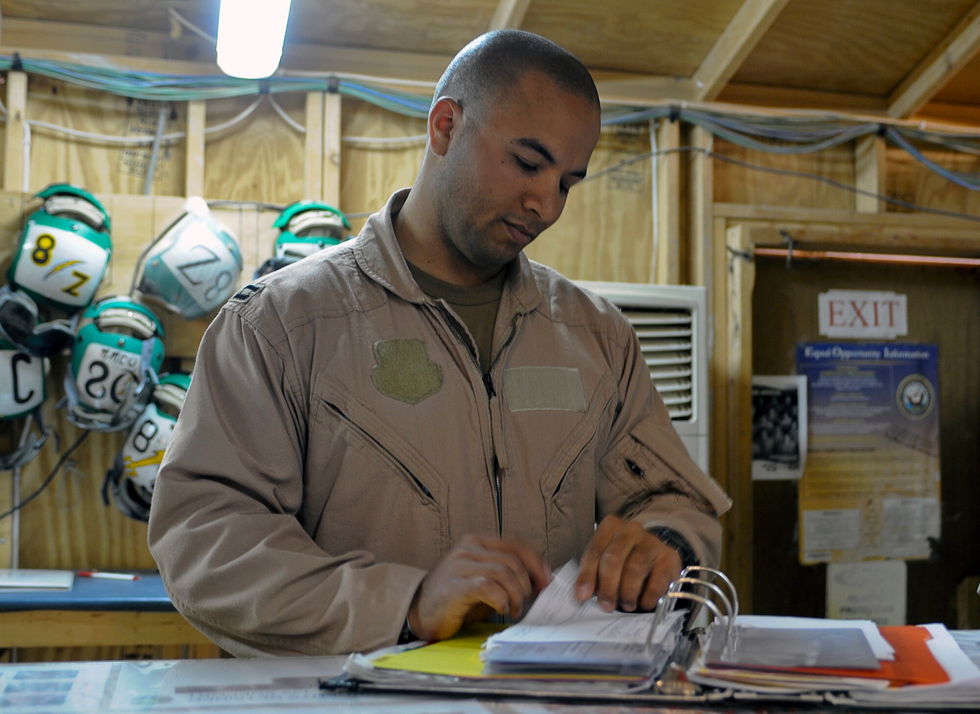 Air Force Capt. Jason Constantine, an electronic warfare officer with the Navy’s VAQ133 Electronic Attack Squadron, looks through the maintenance book prior to a mission launch at Al Asad Airfield, Iraq, April 29, 2010. Captain Constantine is one of four AF EWOs flying with Navy personnel on the A6B-Prowler to conduct aerial over watch operations for convoys at Al Asad. The AF officers are assigned to the 366th Fighter Wing at Mountain Home Air Force Base, Idaho, and work with their counterparts at Naval Air Station Whidbey Island, Wash., in the 388th Electronic Combat Squadron.  (U.S. Air Force photo/Master Sgt. Linda C. Miller/Released)