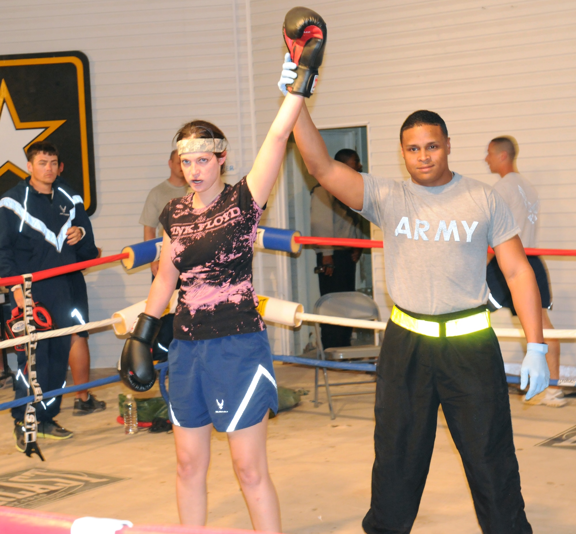 Staff Sgt. Sandra Mihovich, 506th Security Forces Squadron military working dog trainer, fights U.S. Air Force opponent, Ashley Bever, during the Smoker III boxing tournament at Kirkuk Regional Air Base, Iraq on May 8, 2010.  Staff Sgt. Vincent Carll, 506th Expeditionary Civil Engineer Squadron, trained Sergeant Mihovich for this event, where she won by unanimous decision. (U.S. Air Force photo/Staff Sgt. Tabitha Kuykendall/Released)
