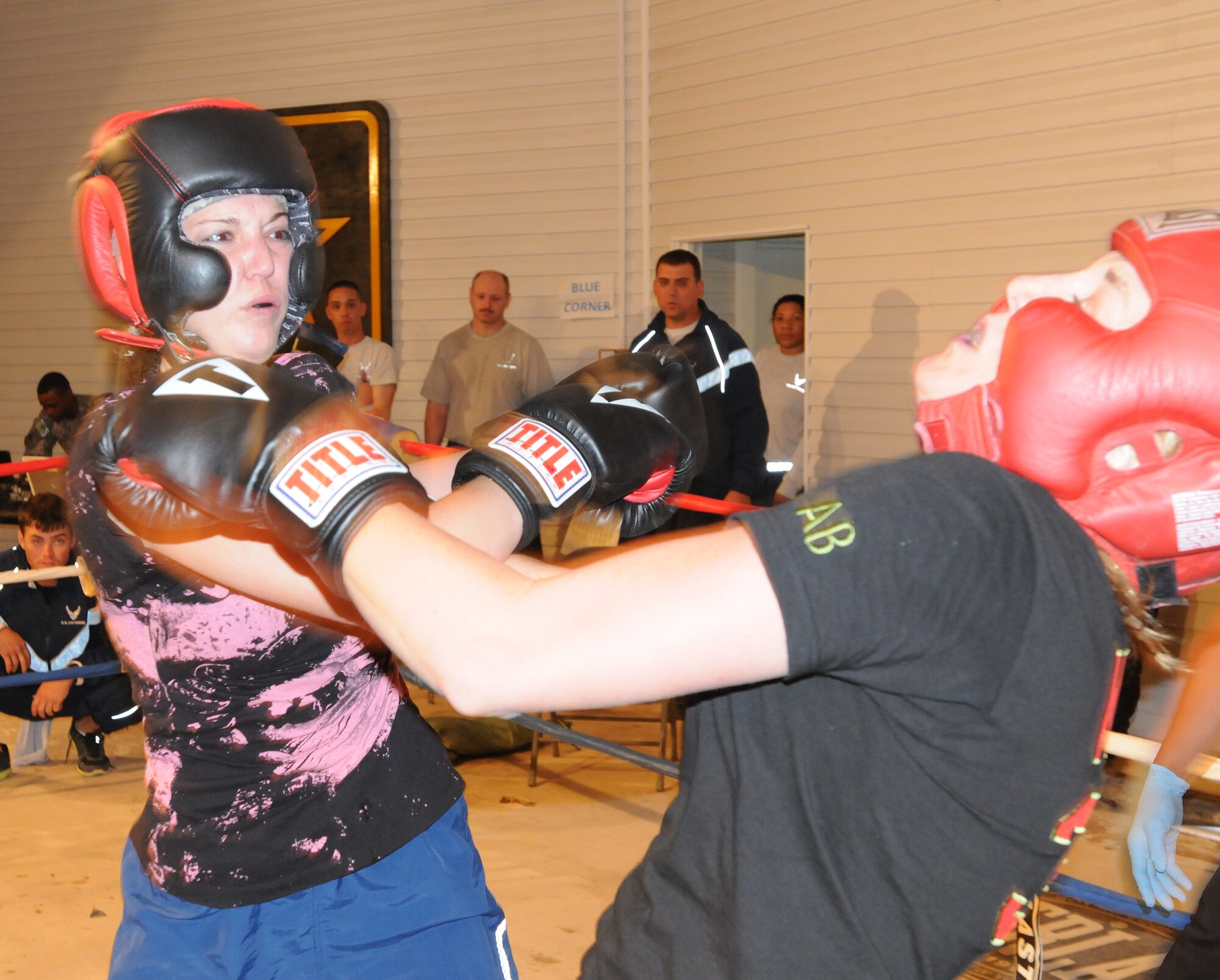 Staff Sgt. Sandra Mihovich, 506th Security Forces Squadron military working dog trainer, fights U.S. Air Force opponent, Ashley Bever, during the Smoker III boxing tournament at Kirkuk Regional Air Base, Iraq on May 8, 2010.  Staff Sgt. Vincent Carll, 506th Expeditionary Civil Engineer Squadron, trained Sergeant Mihovich for this event, where she won by unanimous decision. (U.S. Air Force photo/Staff Sgt. Tabitha Kuykendall/Released)
