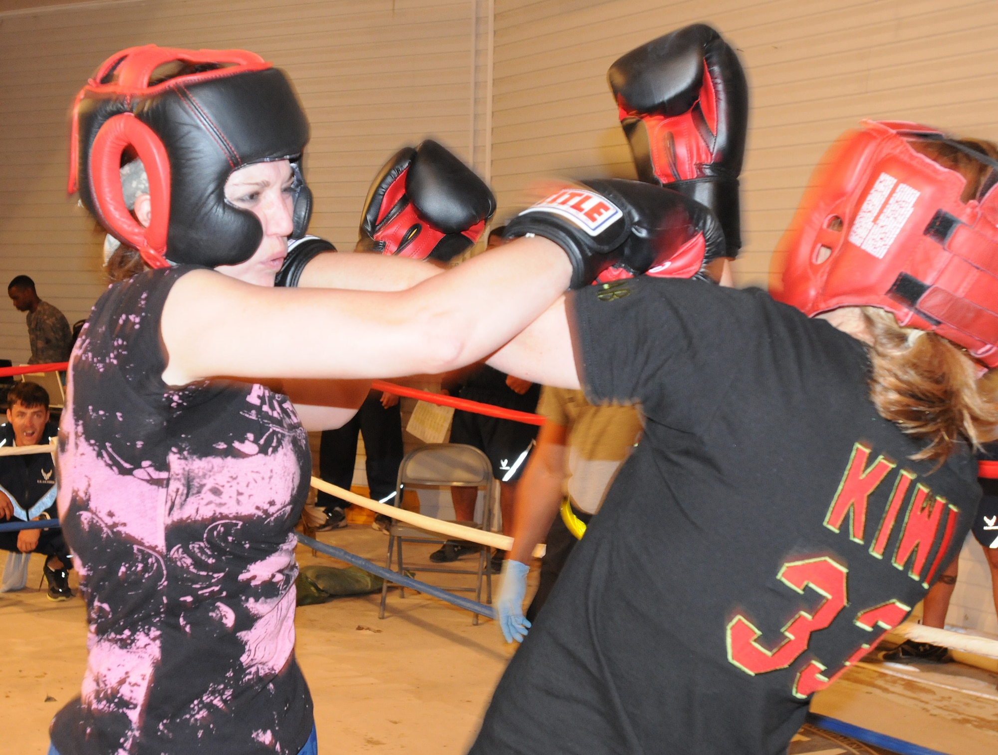 Staff Sgt. Sandra Mihovich, 506th Security Forces Squadron military working dog trainer, fights U.S. Air Force opponent, Ashley Bever, during the Smoker III boxing tournament at Kirkuk Regional Air Base, Iraq on May 8, 2010.  Staff Sgt. Vincent Carll, 506th Expeditionary Civil Engineer Squadron, trained Sergeant Mihovich for this event, where she won by unanimous decision. (U.S. Air Force photo/Staff Sgt. Tabitha Kuykendall/Released)
