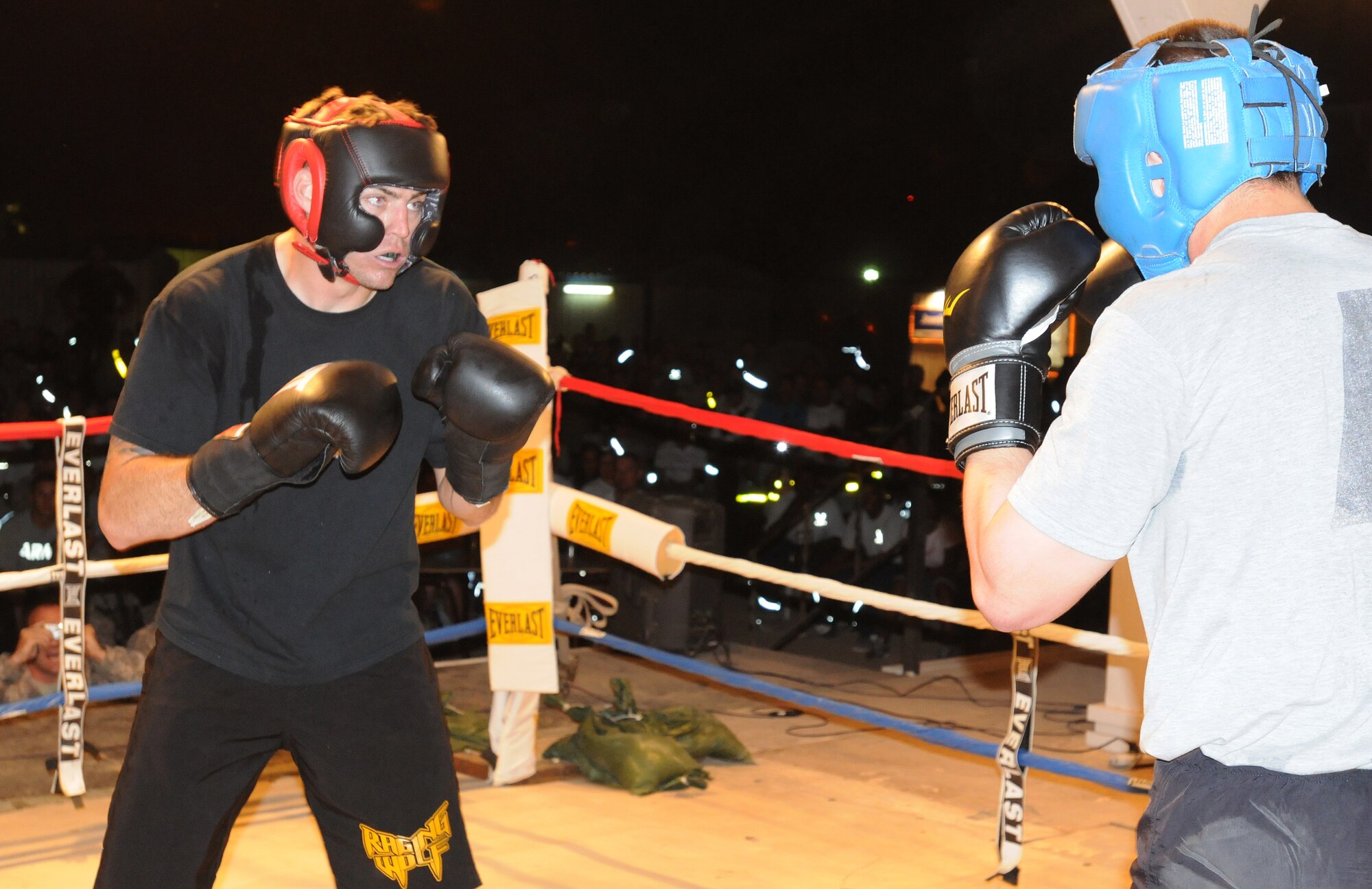Staff Sgt. Vincent Carll, 506th Expeditionary Civil Engineer Squadron heavy equipment operator, fights U.S. Army opponent, Joseph Jedrzejek, during the Smoker III boxing tournament at Kirkuk Regional Air Base, Iraq on May 8, 2010.  Sergeant Carll won by unanimous decision.  He is deployed from Homestead Air Reserve Base, Fla.  (U.S. Air Force photo/Staff Sgt. Tabitha Kuykendall/Released) 