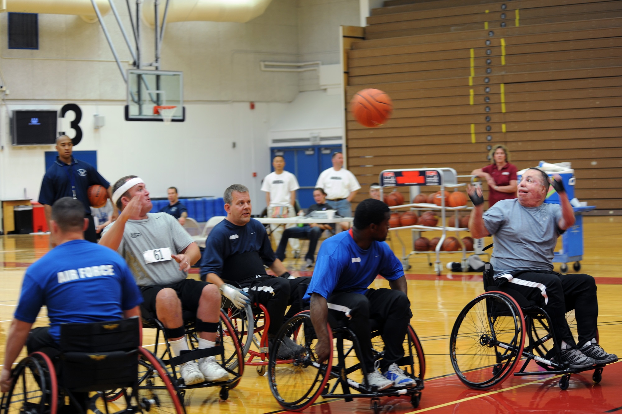Staff Sgt. Richard Pollock II (second from the left) passes the basketball to Tech. Sgt. Israel Del Toro (right) during practice May 10, 2010, at the Olympic Training Center in Colorado Springs, Colo. Sergeants Pollock and Del Toro are members of the Air Force wheelchair basketball team.  Teams from the Air Force, Army, Navy, Marines and Coast Guard are participating in the inaugural Warrior Games which begin May 10 and finish May 14.  (U.S. Air Force photo/Staff Sgt. Desiree N. Palacios)