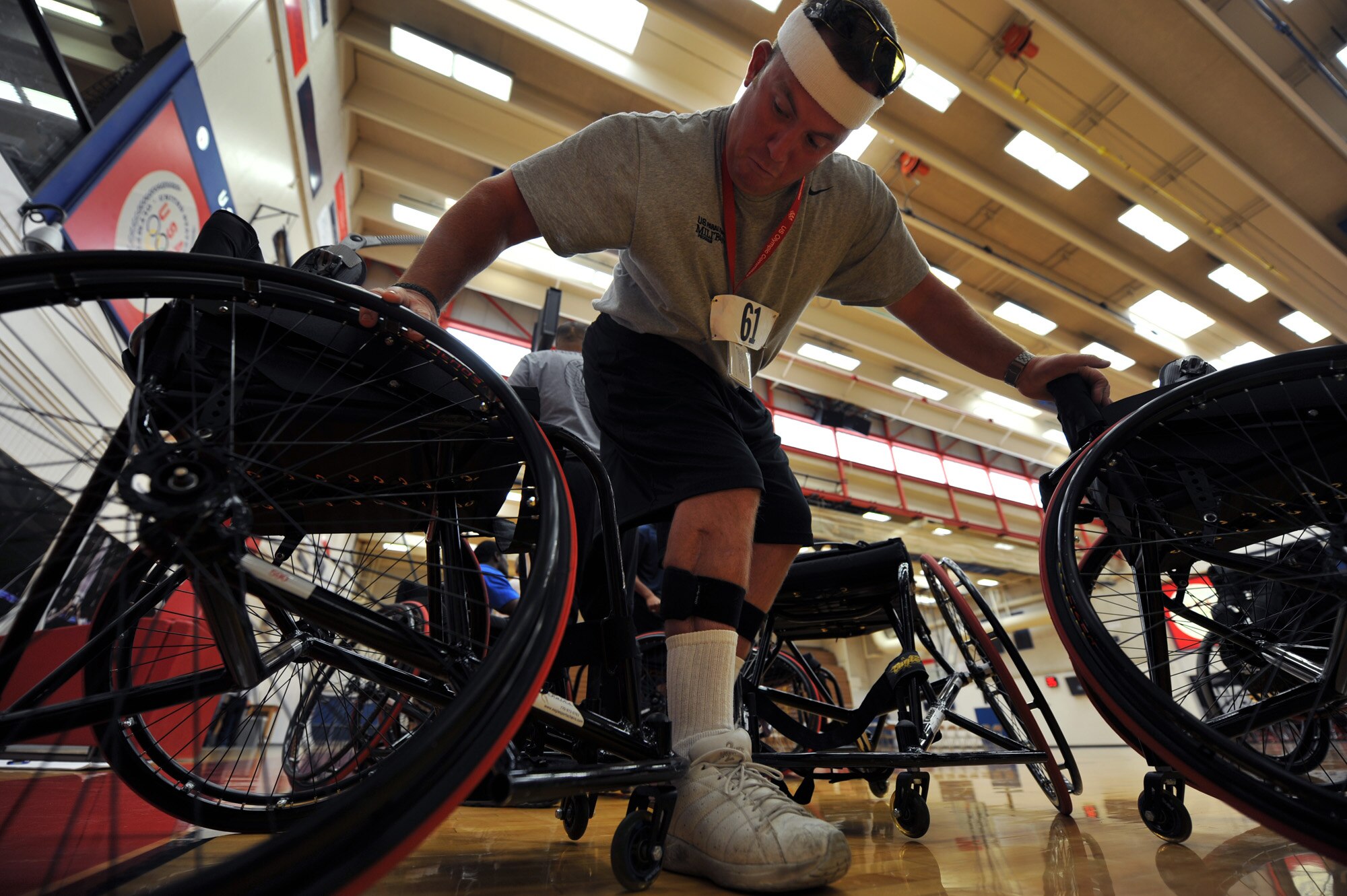 Staff Sgt. Richard Pollock II moves into his wheelchair as he prepares to practice basketball May 10, 2010, at the Olympic Training Center in Colorado Springs, Colo. Sergeant Pollock is a member of the Air Force wheelchair basketball team. Teams from the Air Force, Army, Navy, Marines and Coast Guard are participating in the inaugural Warrior Games which begin May 10 and finish May 14.  (U.S. Air Force photo/Staff Sgt. Desiree N. Palacios)