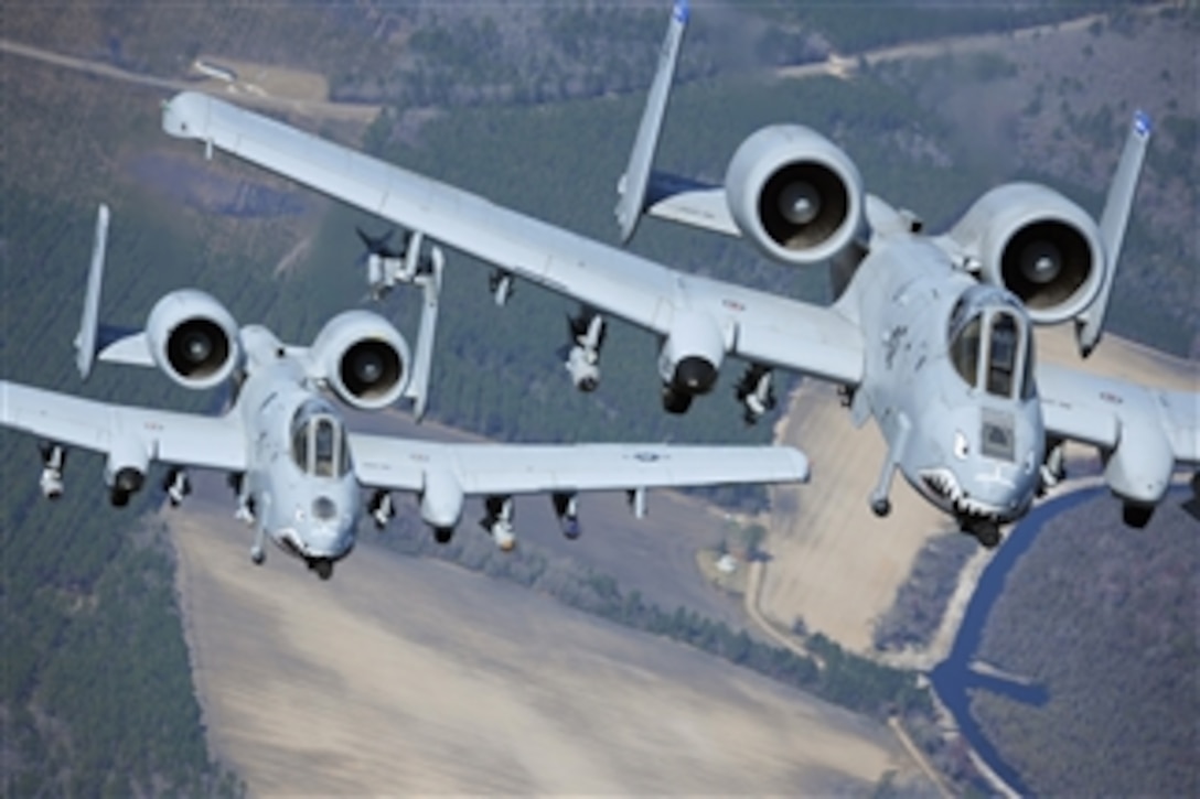 Two A-10C Thunderbolt II aircraft fly in formation during a training exercise at Moody Air Force, Ga., on March 16, 2010.  Members of the 74th Fighter Squadron performed surge operations to push its support function to the limit and simulate pilots' wartime flying rates.  