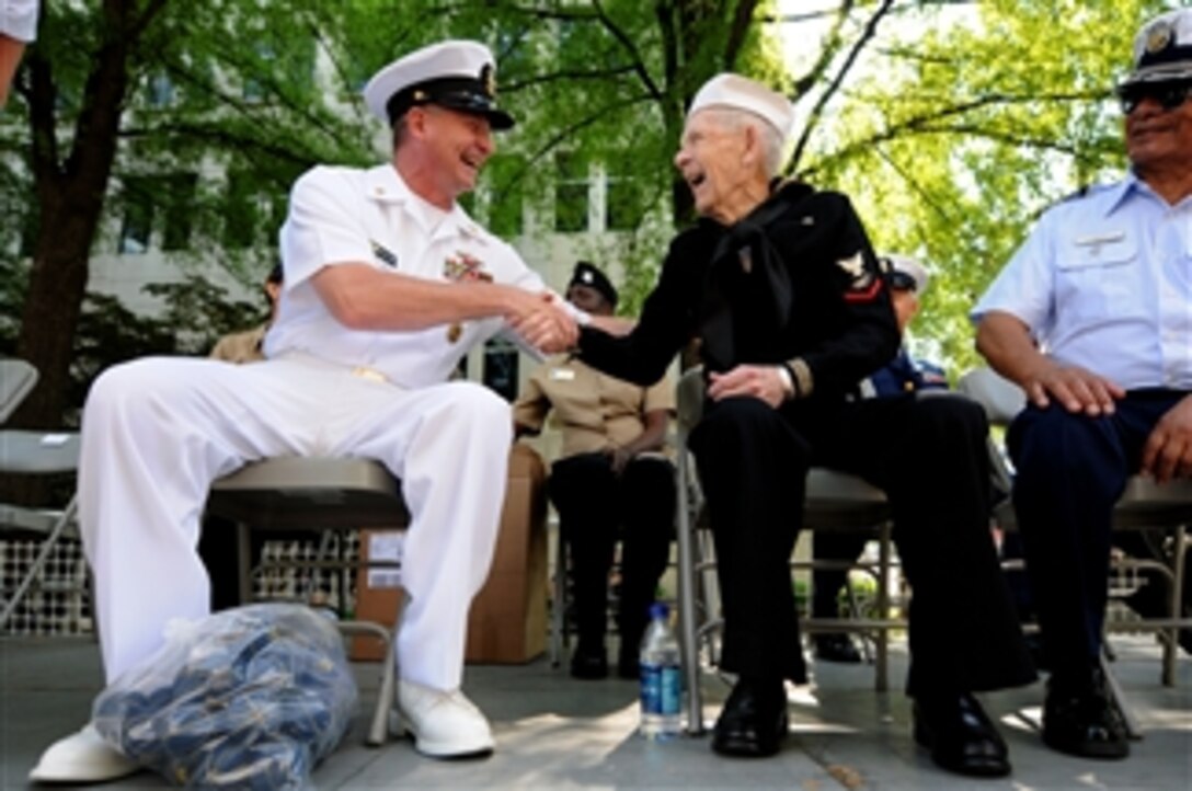 Master Chief Petty Officer of the Navy Rick West meets Con Crabb on the reviewing stand for the 61st Armed Forces Day Parade in Chattanooga, Tenn., on May 7, 2010.  Crabb was a Radarman 3rd class during World War II.  West was Grand Marshall and Reviewing Officer for the parade. 