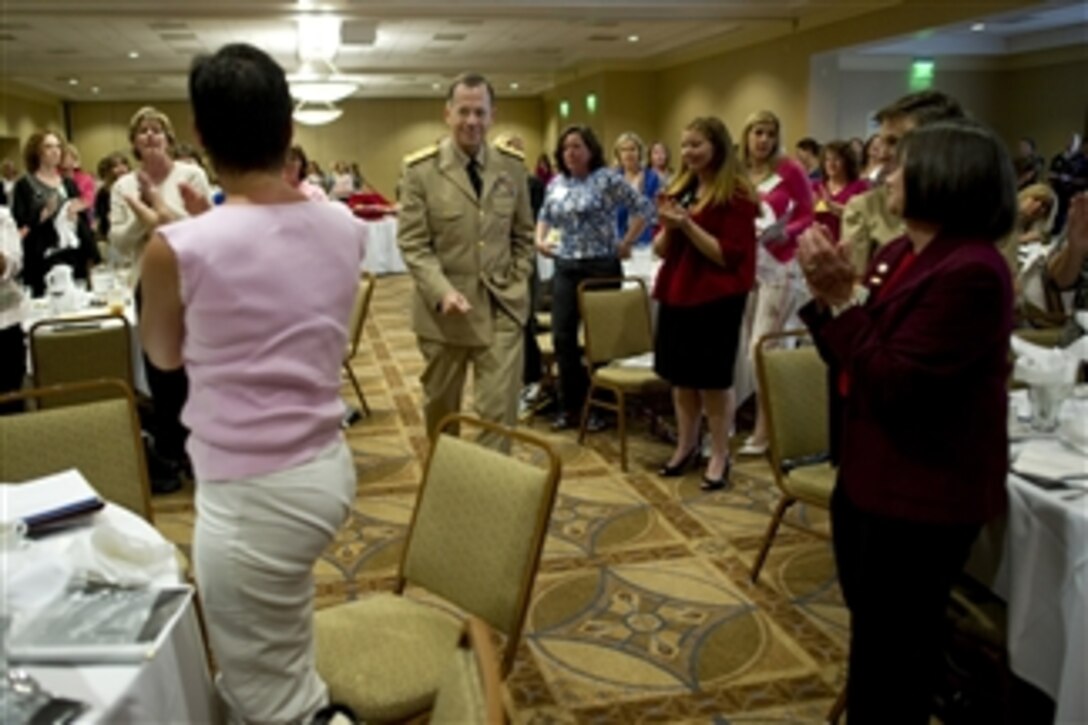 Chairman of the Joint Chiefs of Staff Adm. Mike Mullen arrives to standing applause at the quarterly Continuum Of Resource Education spouses meeting at Naval Station Norfolk, Va., on May 9, 2010.  Mullen and his wife Deborah addressed attendees at the Norfolk Fleet and Family Support Center that hosts meetings designed to aide spouses in leadership positions and the challenges they face filling these demanding positions.  