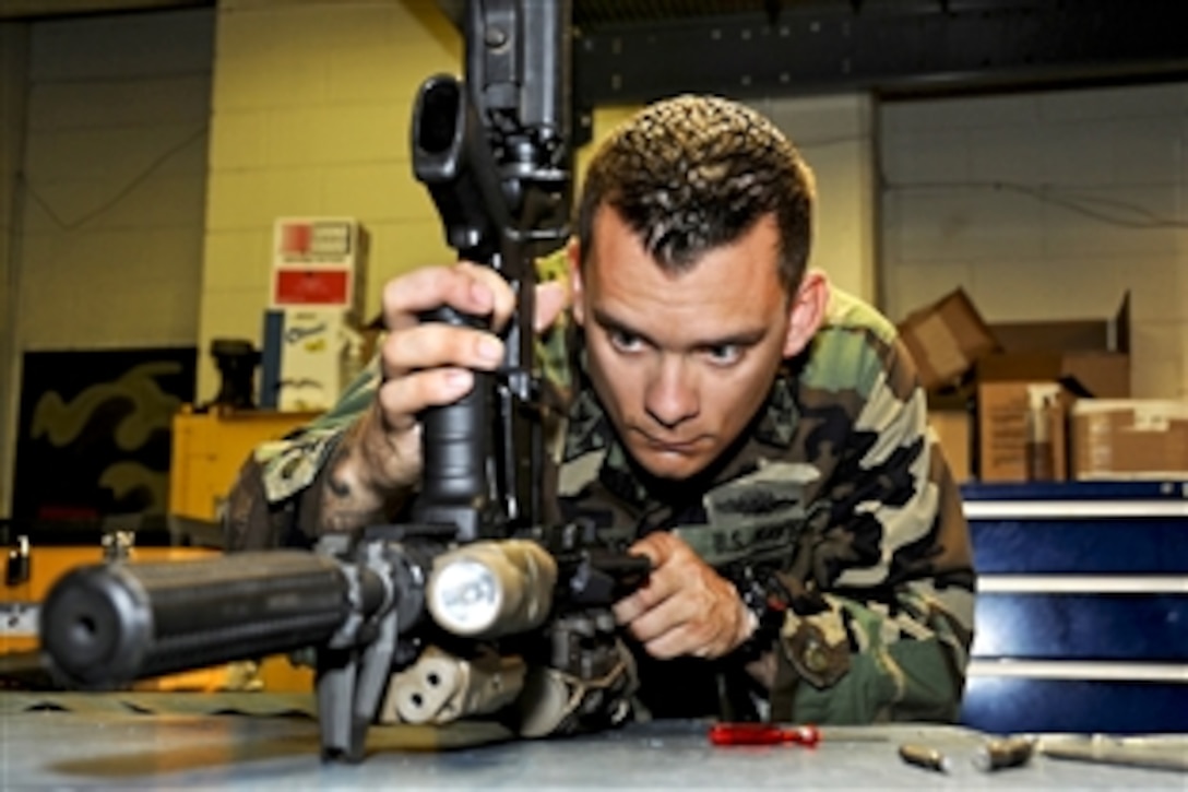 U.S. Navy Petty Officer 1st Class John Mathewson field-strips an M-4 carbine for an inspection in Virginia Beach, Va., May 6, 2010. Mathewson was recently named the Naval Special Warfare Group 4 shore-side "Sailor of the Year" for the second year in a row. He also earned the title as one of the top five sailors competing for the Vice Chief of Naval Operations Sailor of the Year title.